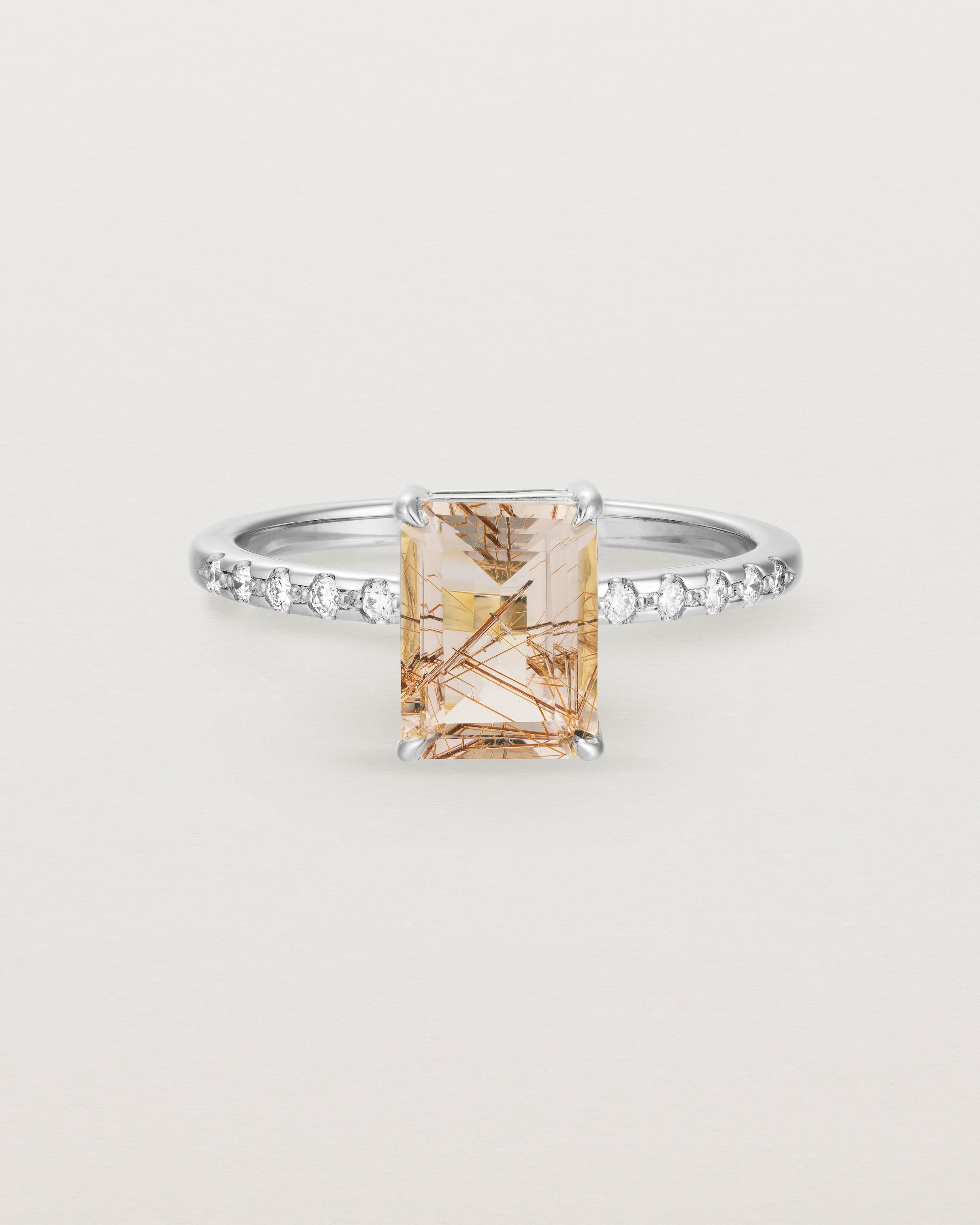 Front view of the Una Emerald solitaire with tourmalinated quartz featuring white diamond shoulders, in white gold.