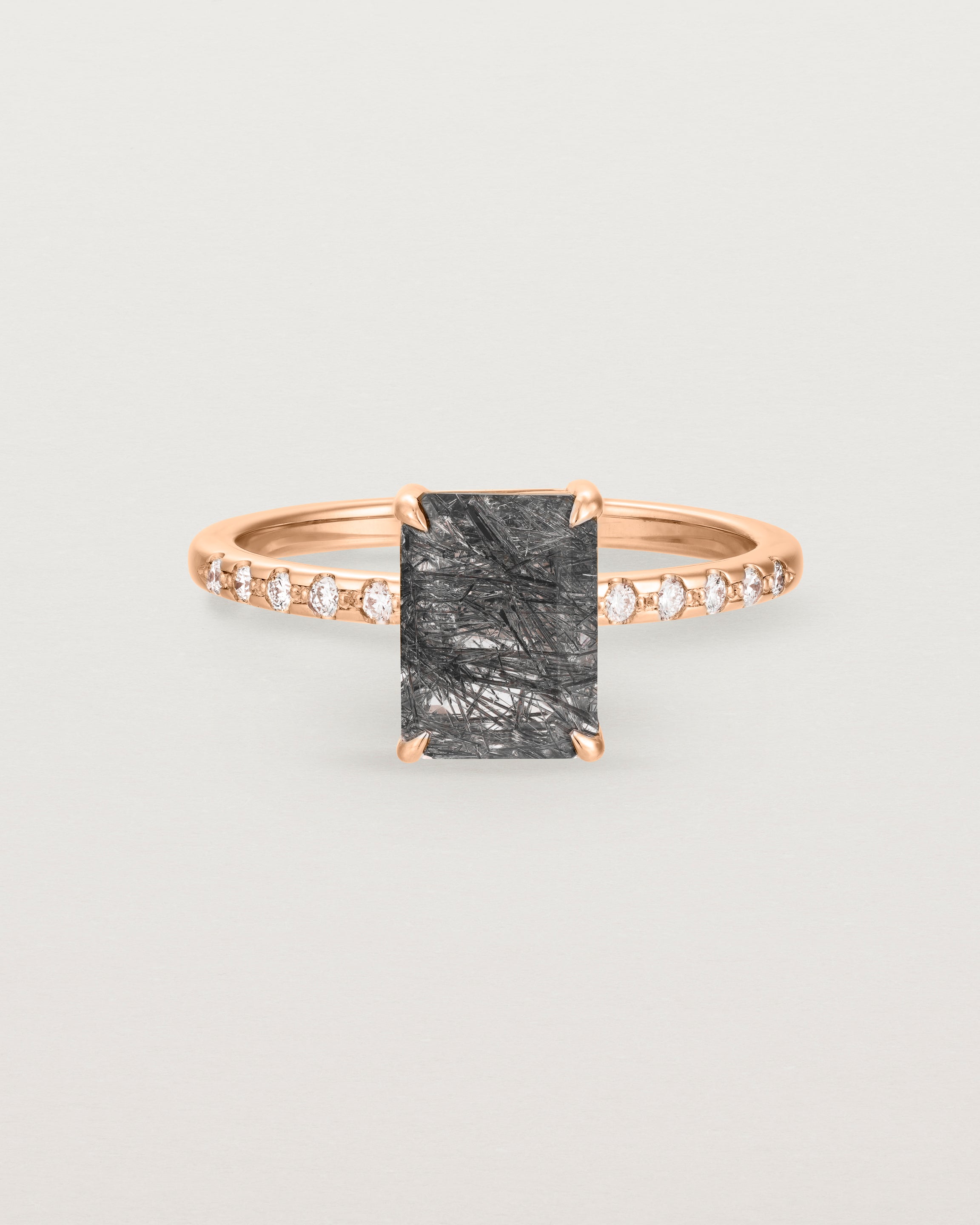 Front view of the Una Emerald solitaire with tourmalinated quartz featuring white diamond shoulders, in rose gold.