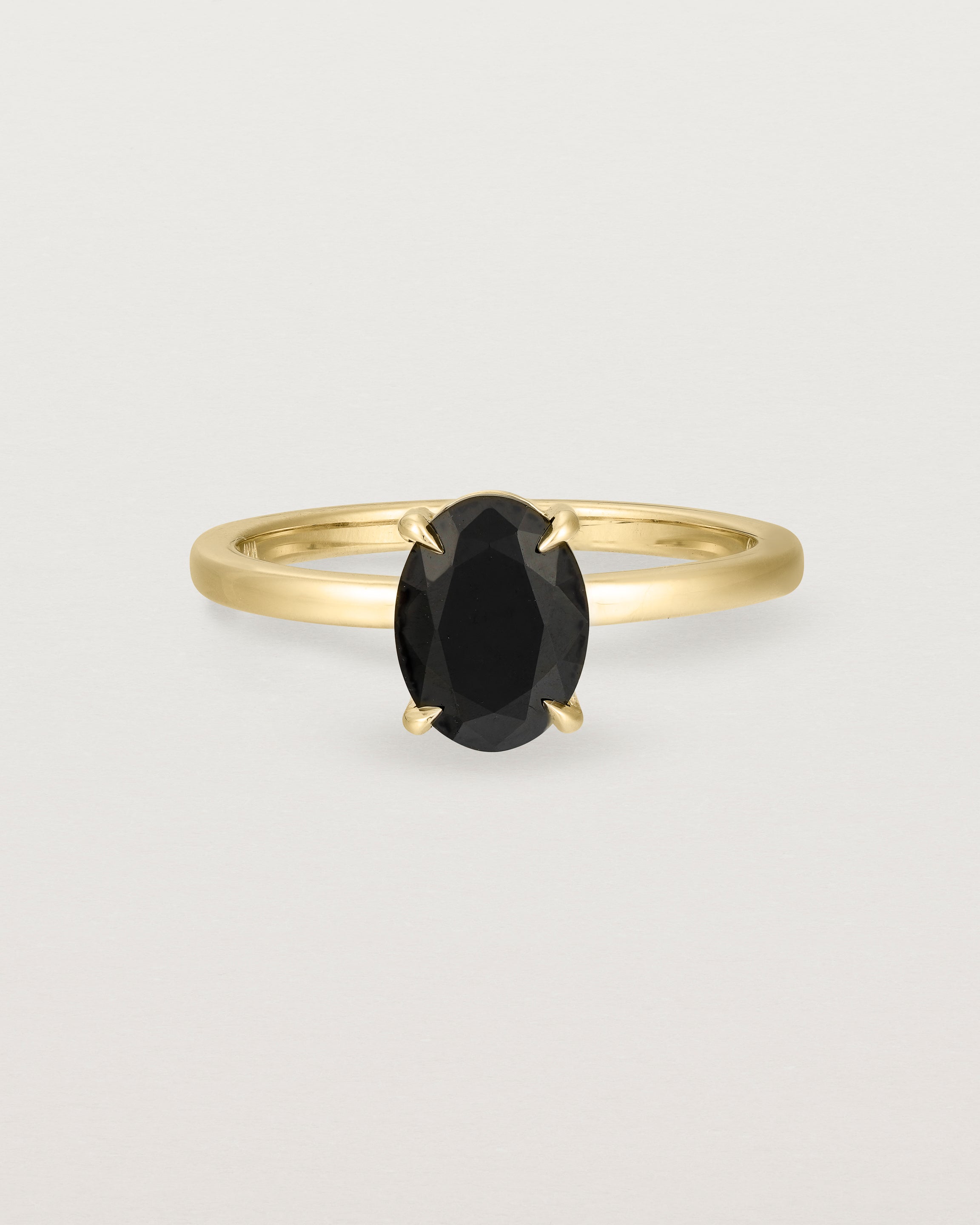 Front view of the Una Oval Solitaire | Black Spinel | Yellow Gold.