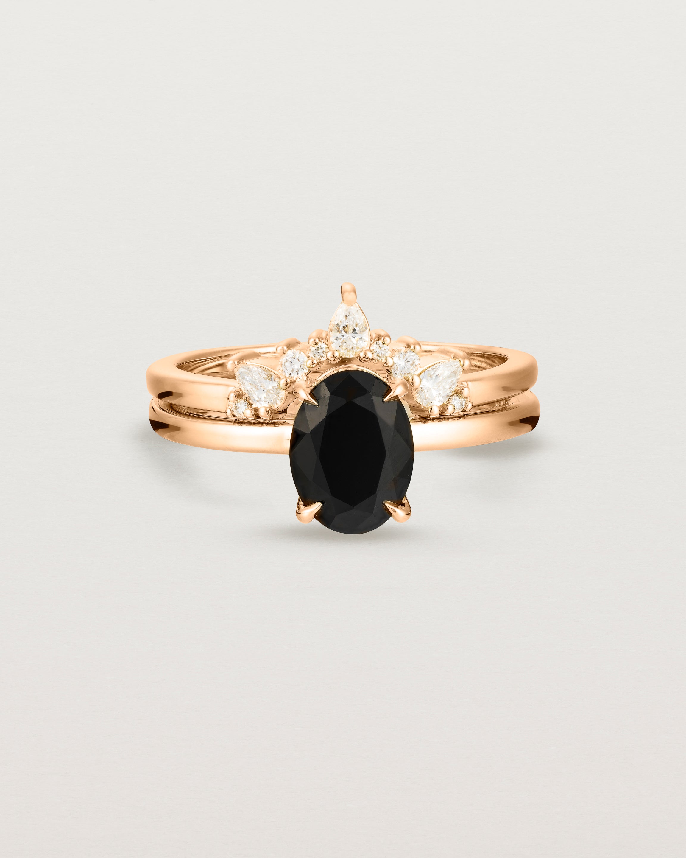 Front view of the Una Oval Solitaire | Black Spinel | Rose Gold stacked with the Odette Crown Ring.