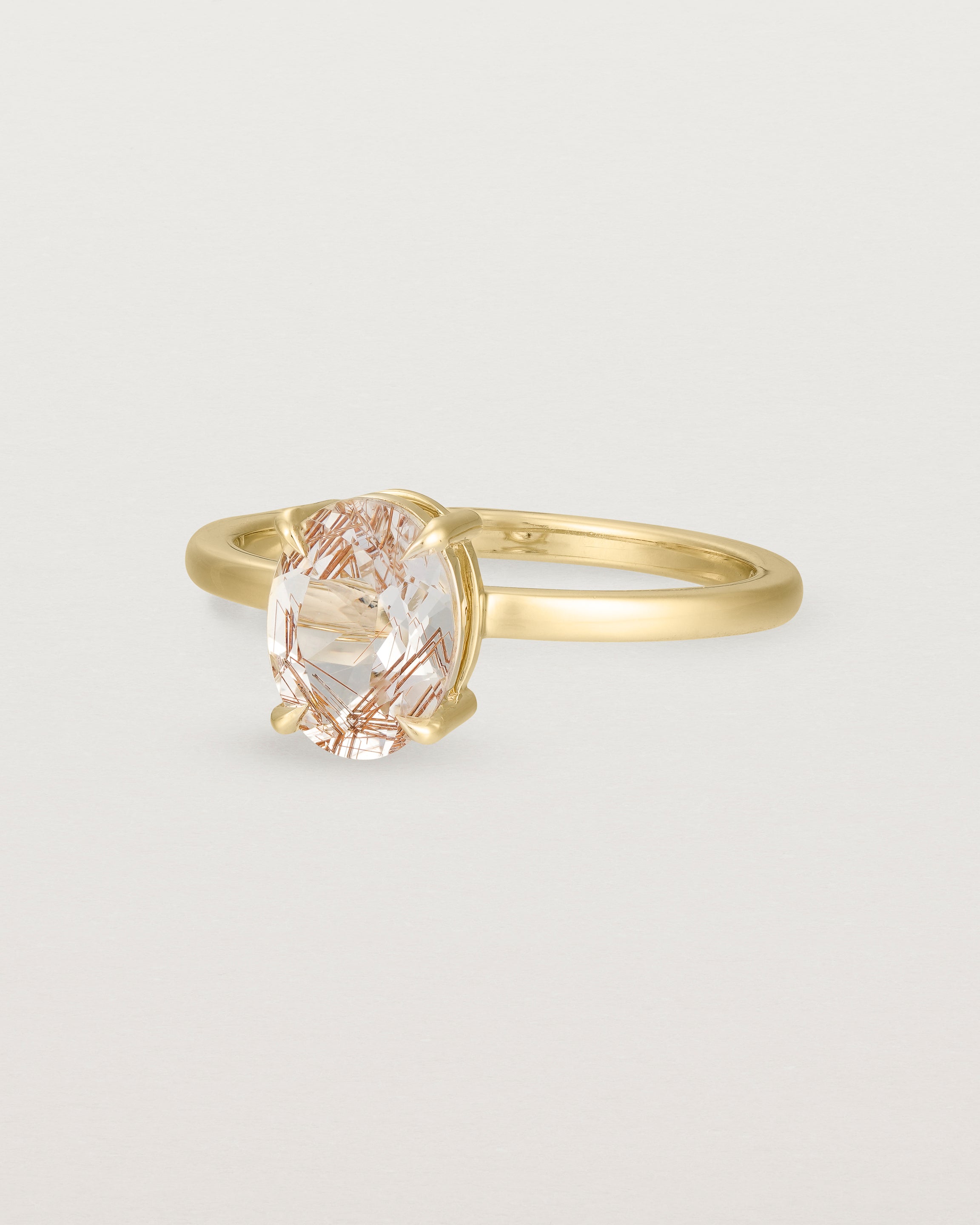 Angled view of the Una Oval Solitaire | Rutilated Quartz | Yellow Gold.