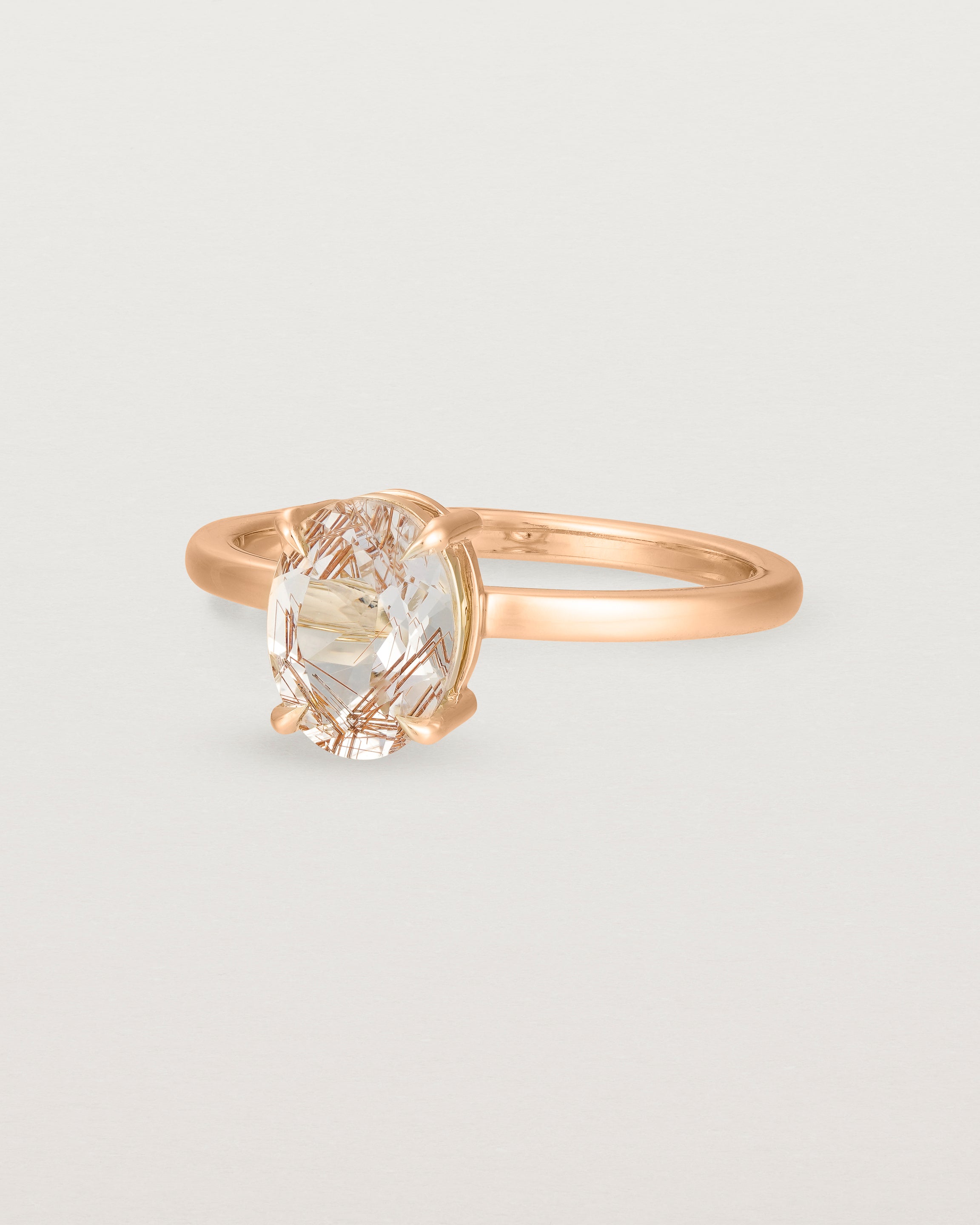 Angled view of the Una Oval Solitaire | Rutilated Quartz | Rose Gold.