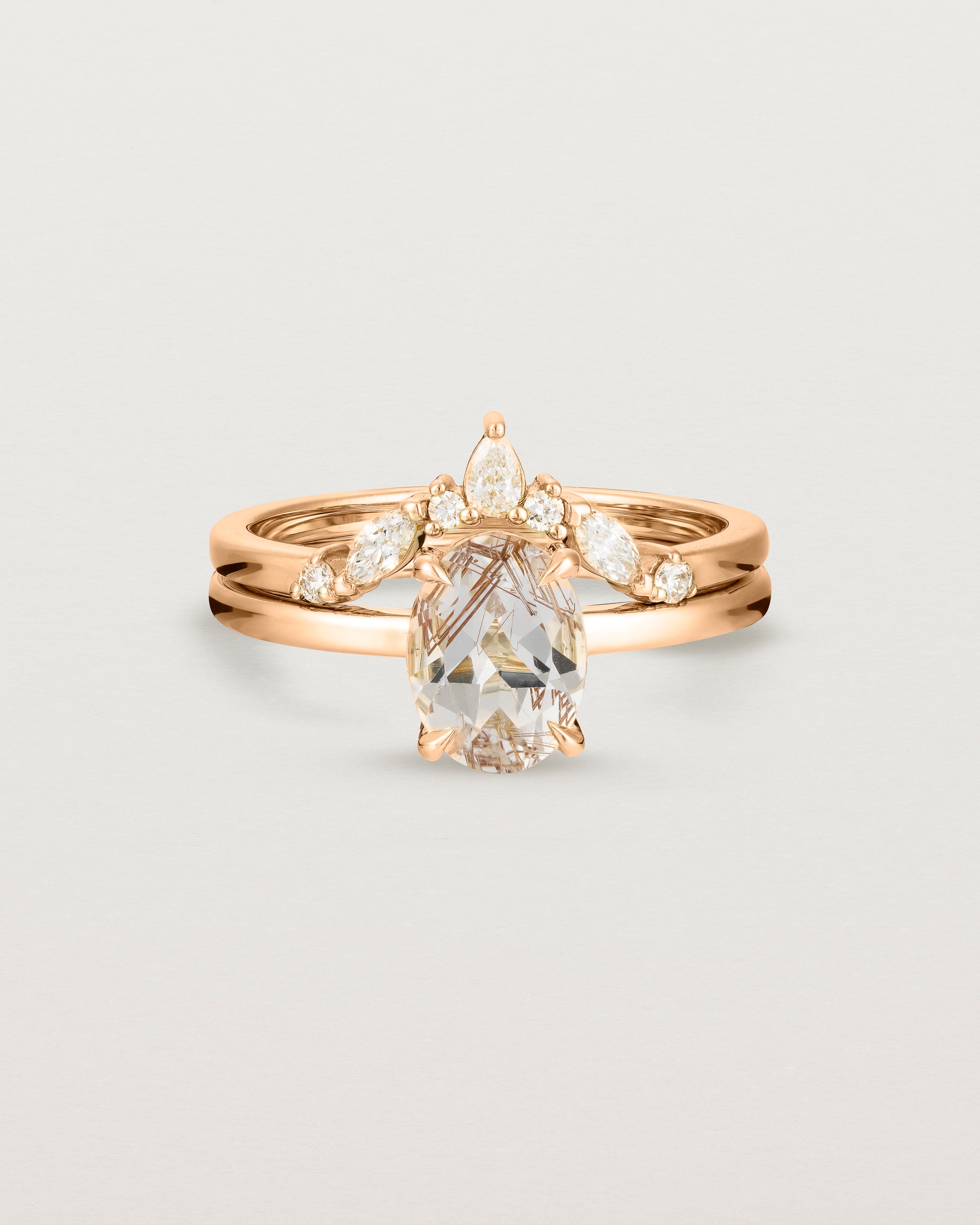 Front view of the Una Oval Solitaire | Rutilated Quartz | Rose Gold stacked with the Meia Crown Ring | Diamonds.