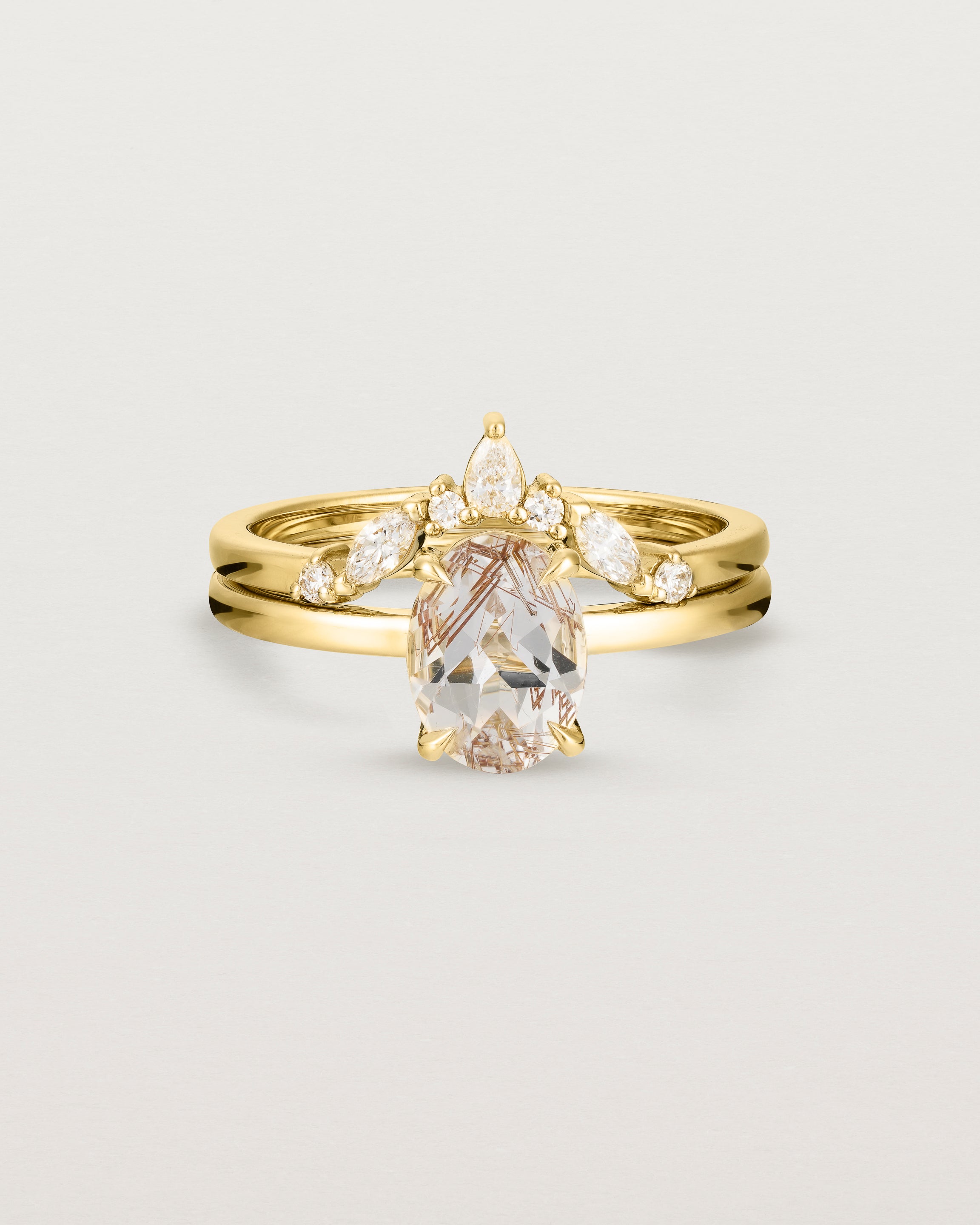 Front view of the Una Oval Solitaire | Rutilated Quartz | Yellow Gold stacked with the Meia Crown Ring | Diamonds.