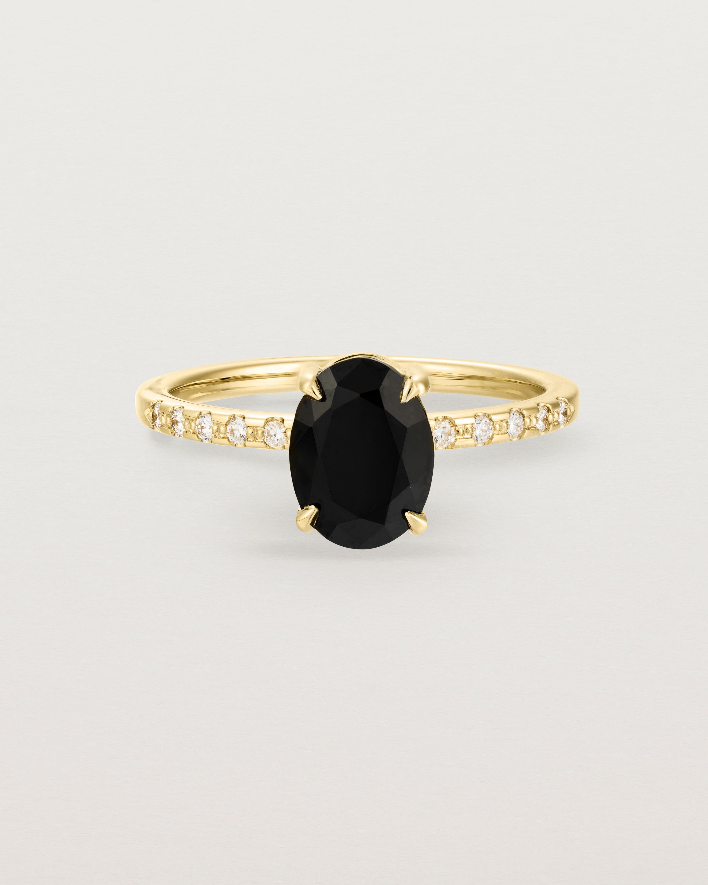 Front view of the Una Oval Solitaire | Black Spinel | Yellow Gold with Cascade Shoulders.