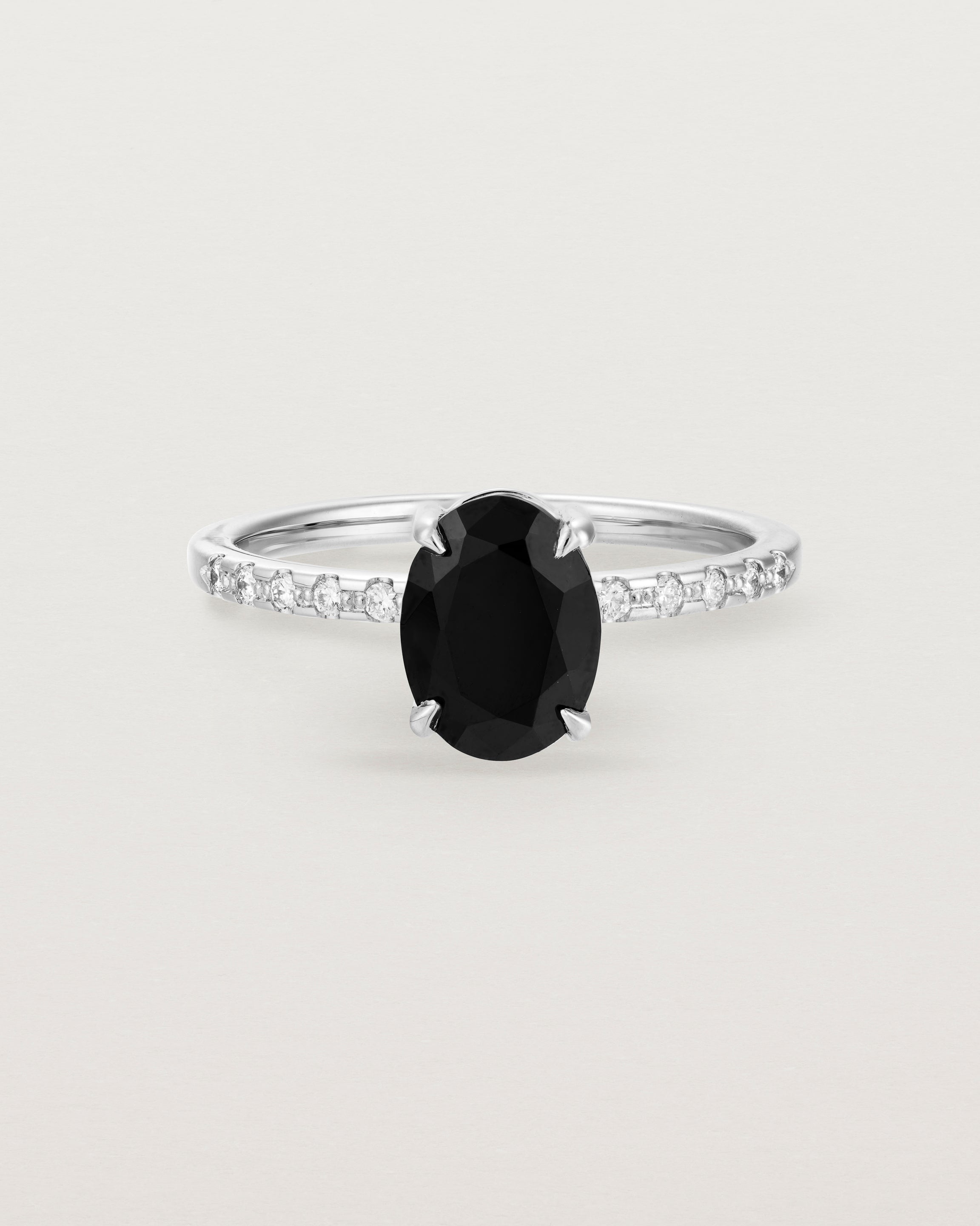 Front view of the Una Oval Solitaire | Black Spinel | White Gold with Cascade Shoulders.