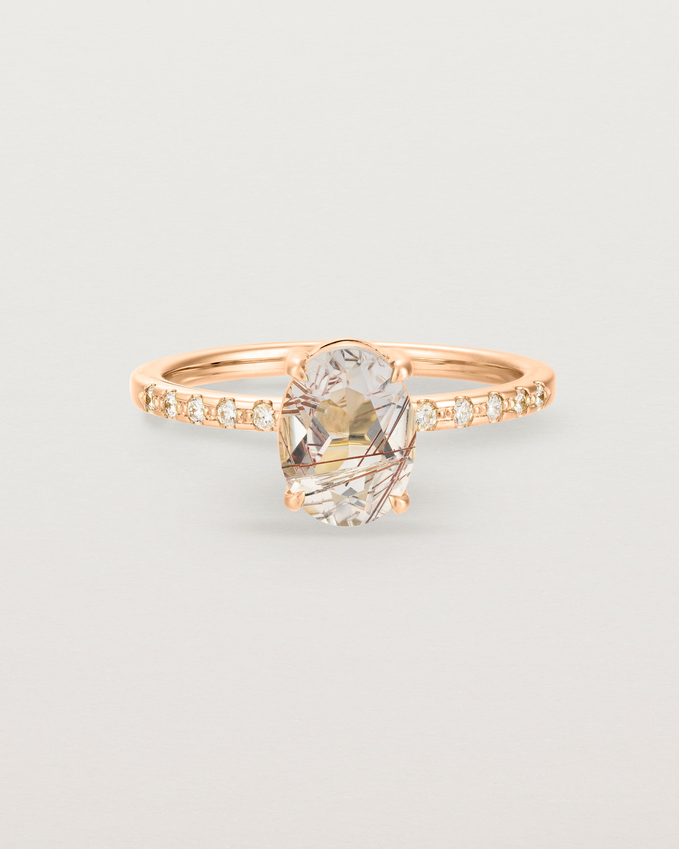 Front view of the Una Oval Solitaire | Rutilated Quartz | Rose Gold with Cascade Diamond shoulders.