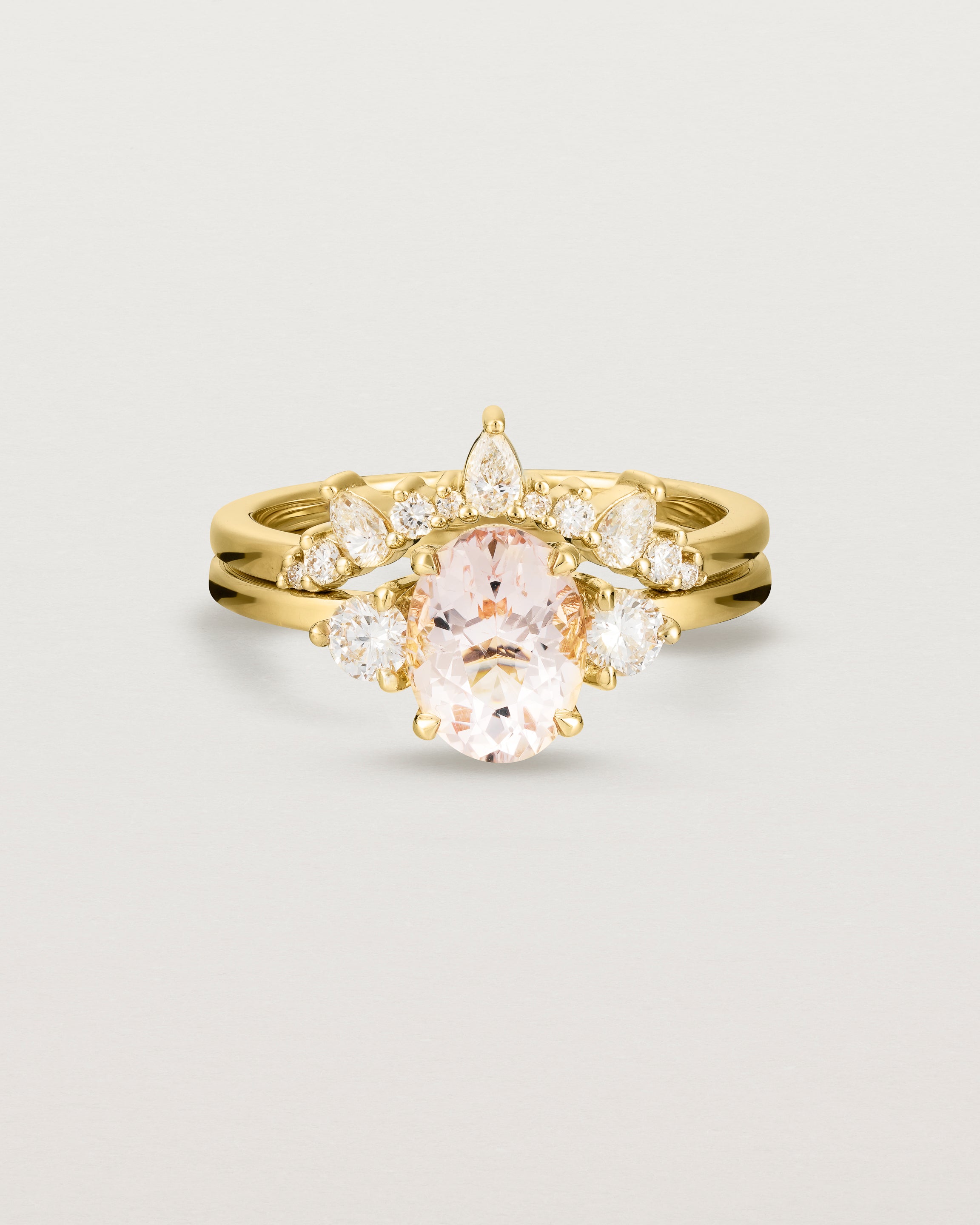  Front view of the Una Oval Trio Ring | Morganite & Diamonds | Yellow Gold stacked with the Odette Crown Ring.