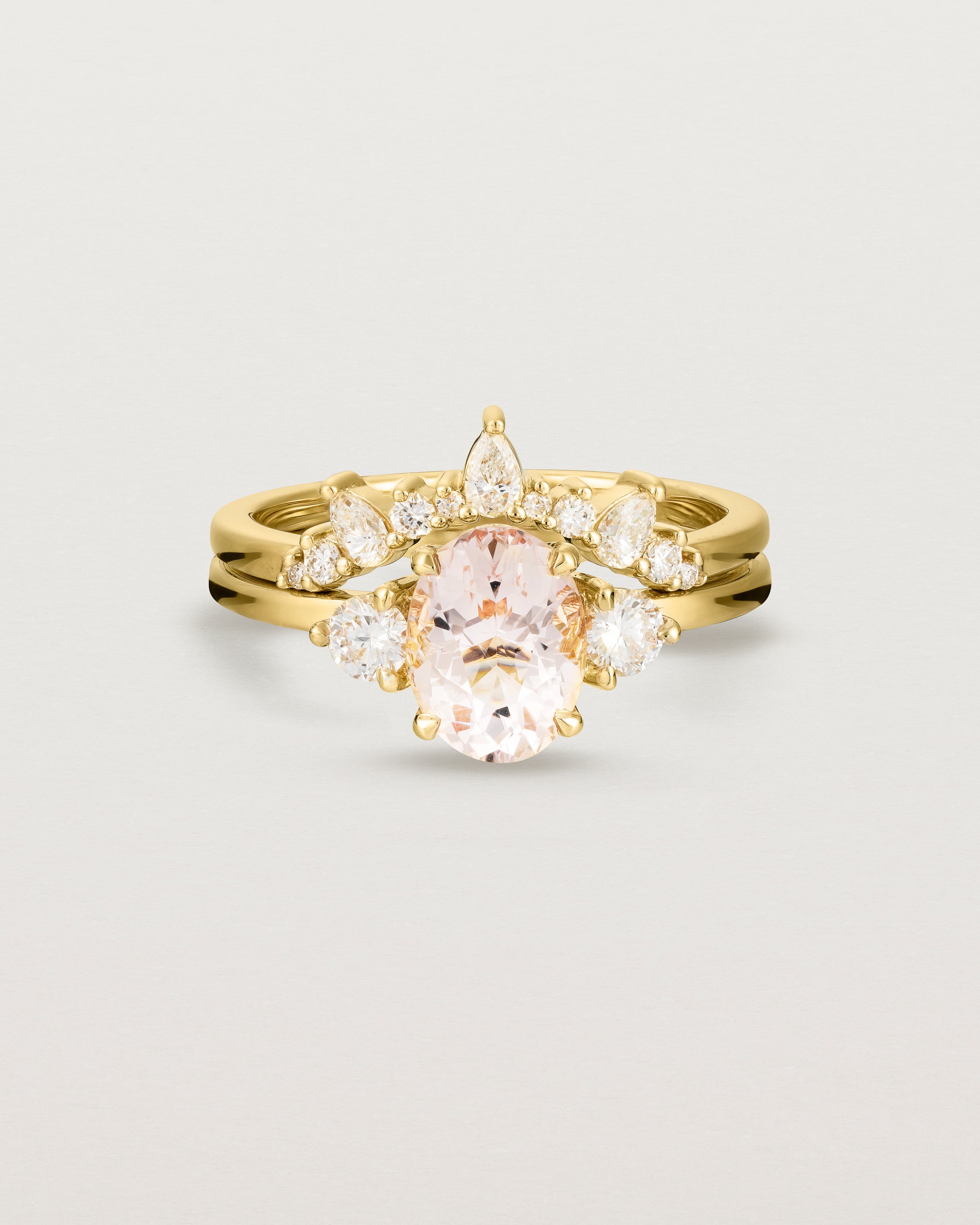  Front view of the Una Oval Trio Ring | Morganite & Diamonds | Yellow Gold stacked with the Odette Crown Ring.