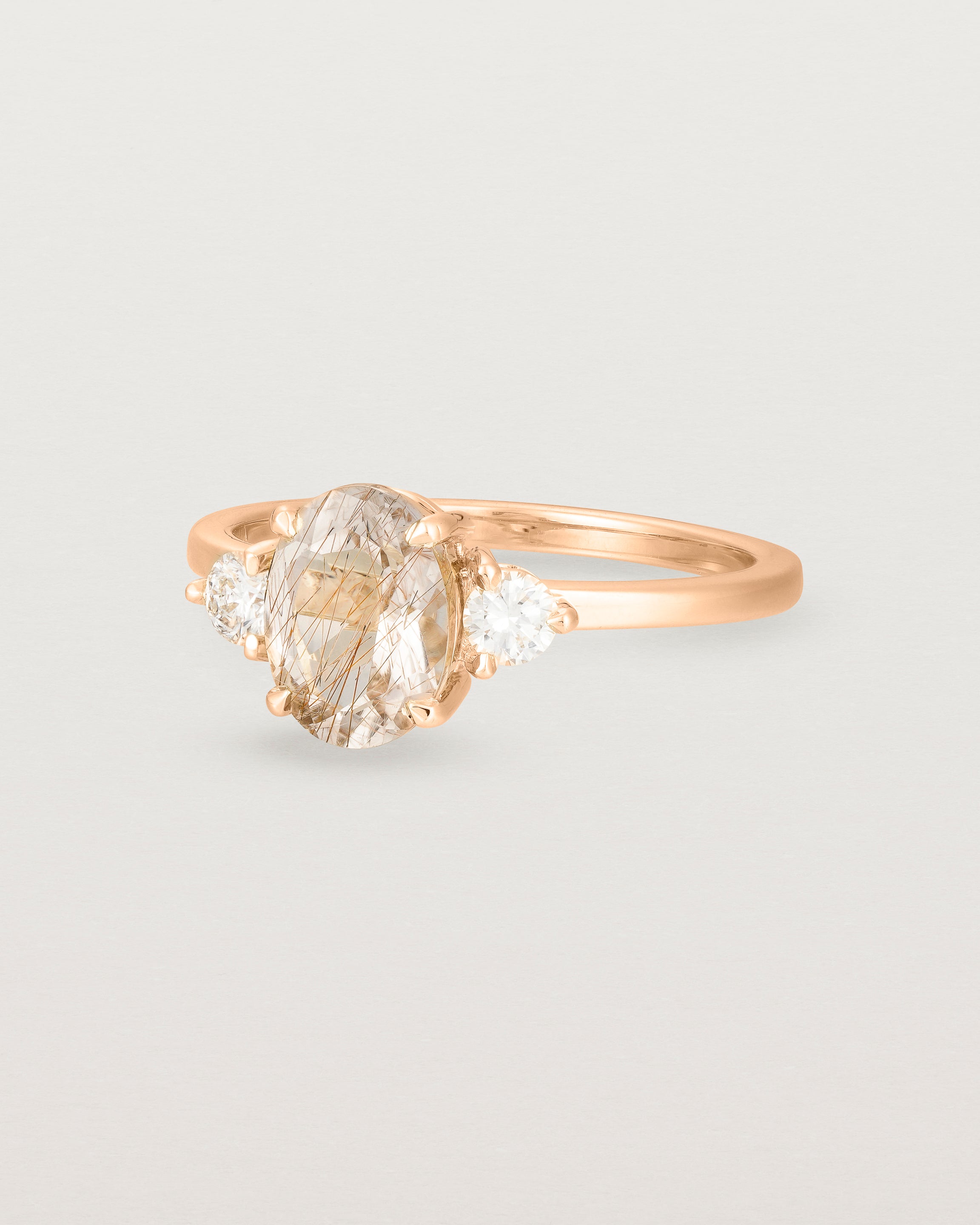 Angled view of the Una Oval Trio Ring | Rutilated Quartz & Diamonds | Rose Gold.