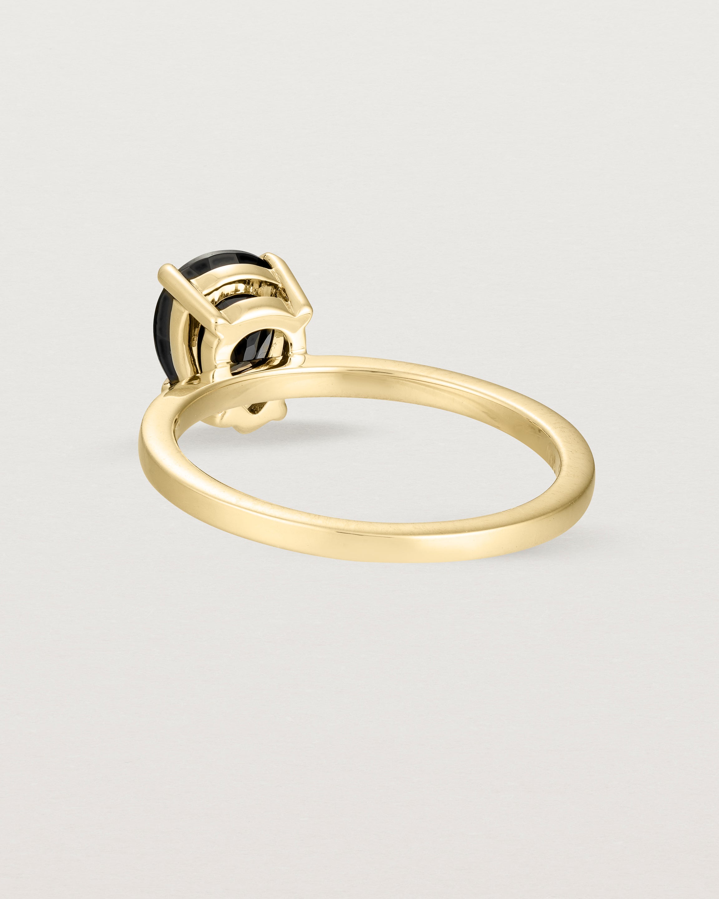 Back view of the Una Pear Solitaire | Black Spinel | Yellow Gold.
