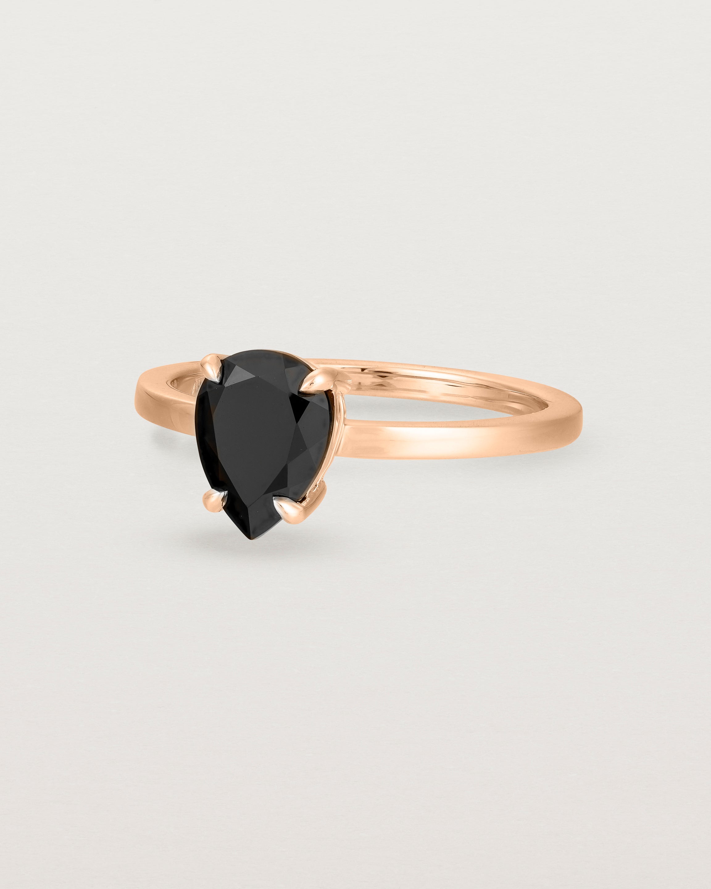 Angled view of the Una Pear Solitaire | Black Spinel | Rose Gold.