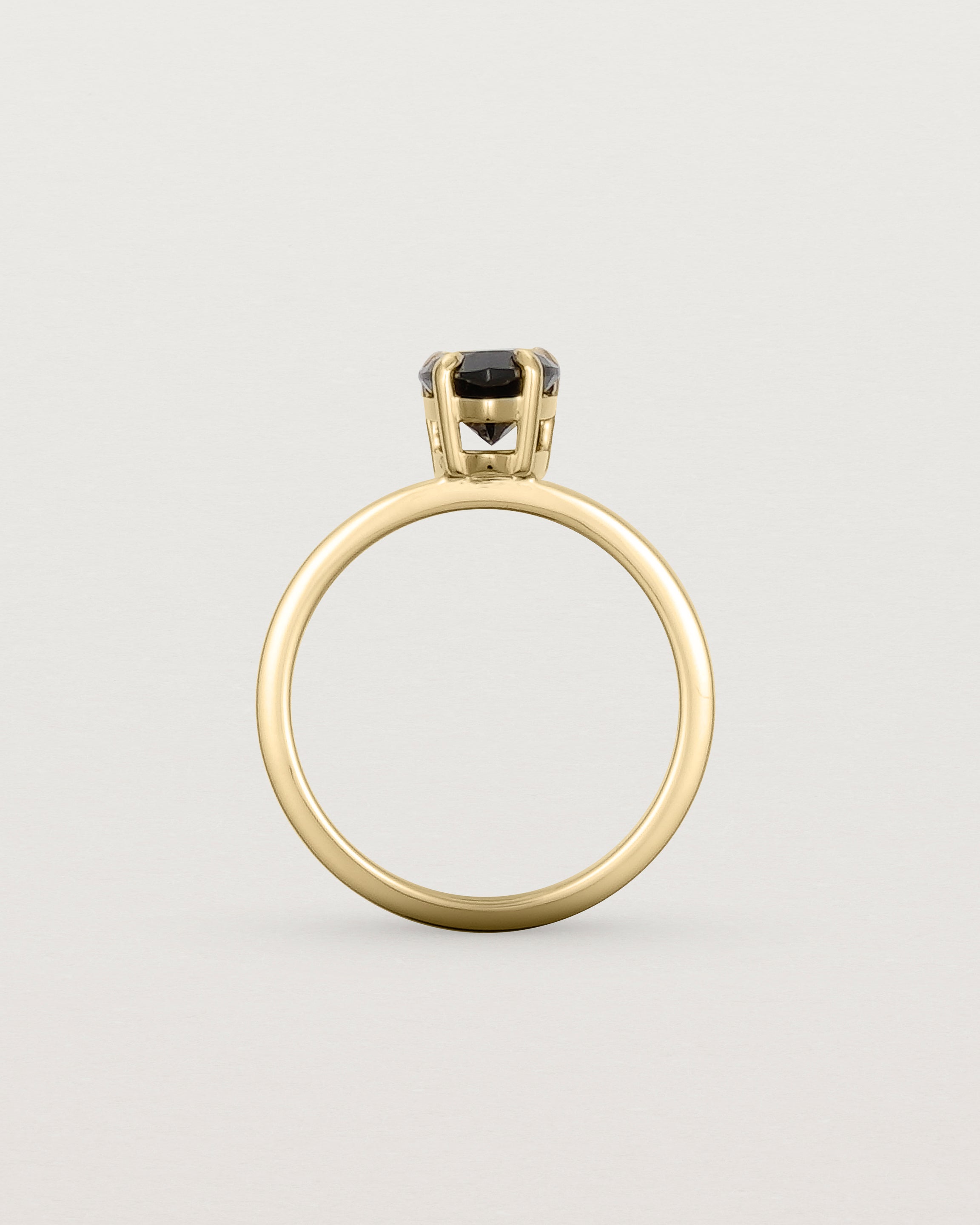 Standing view of the Una Pear Solitaire | Black Spinel | Yellow Gold.