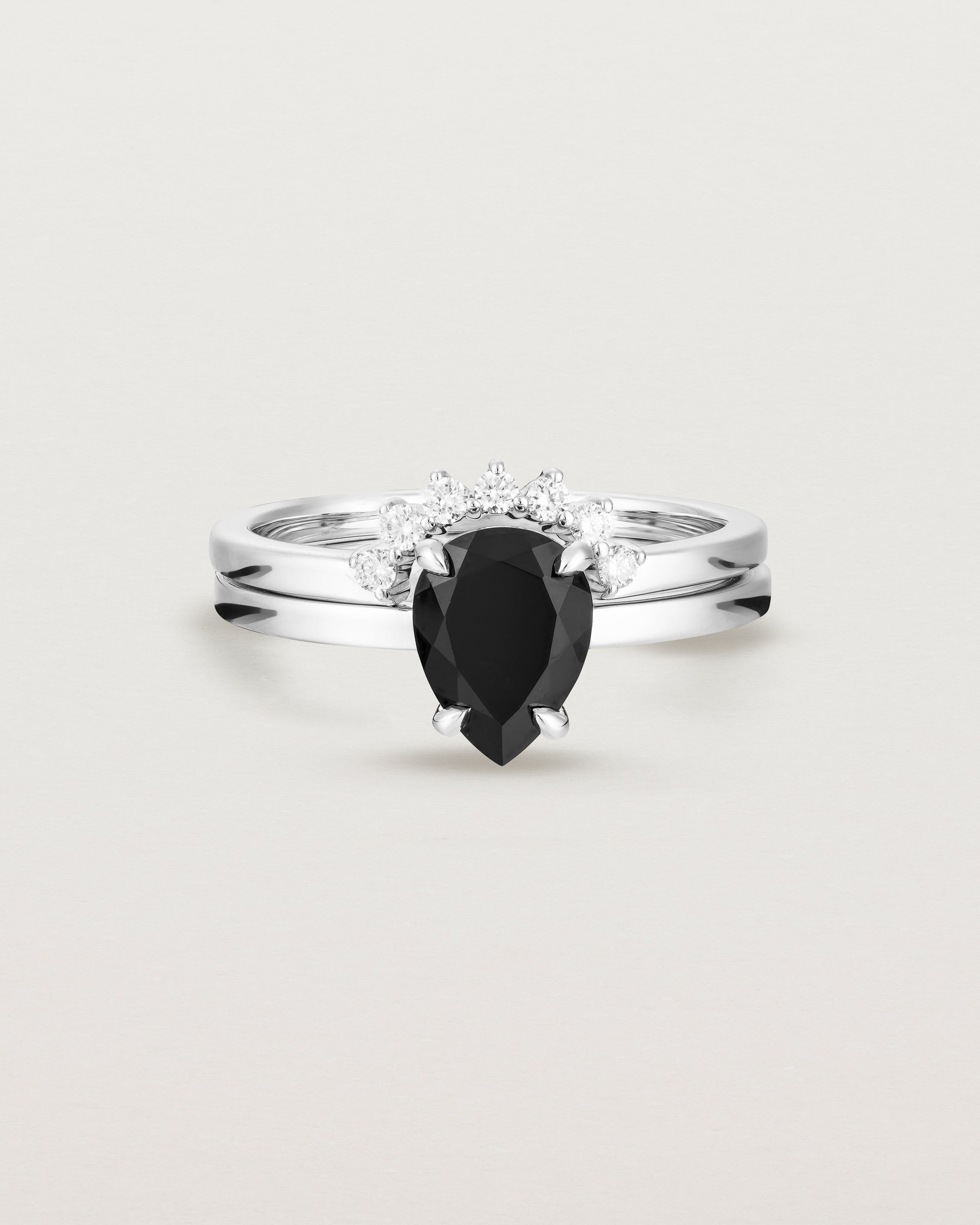 Front view of the Una Pear Solitaire | Black Spinel | White Gold stacked with the Reina Crown Ring | Diamonds.