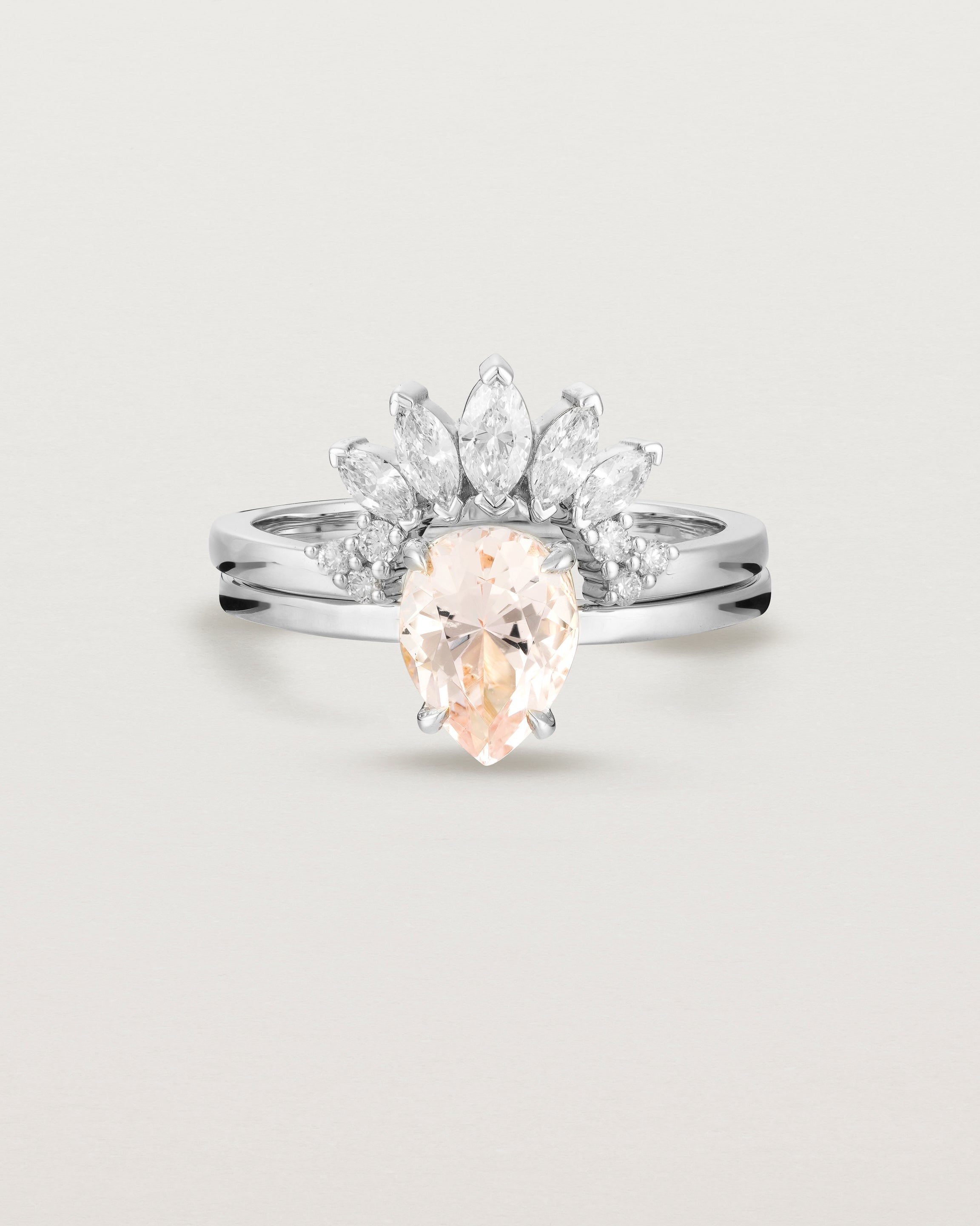 Front view of the Una Pear Solitaire | Morganite | White Gold stacked with the Camille Crown Ring | Diamonds.
