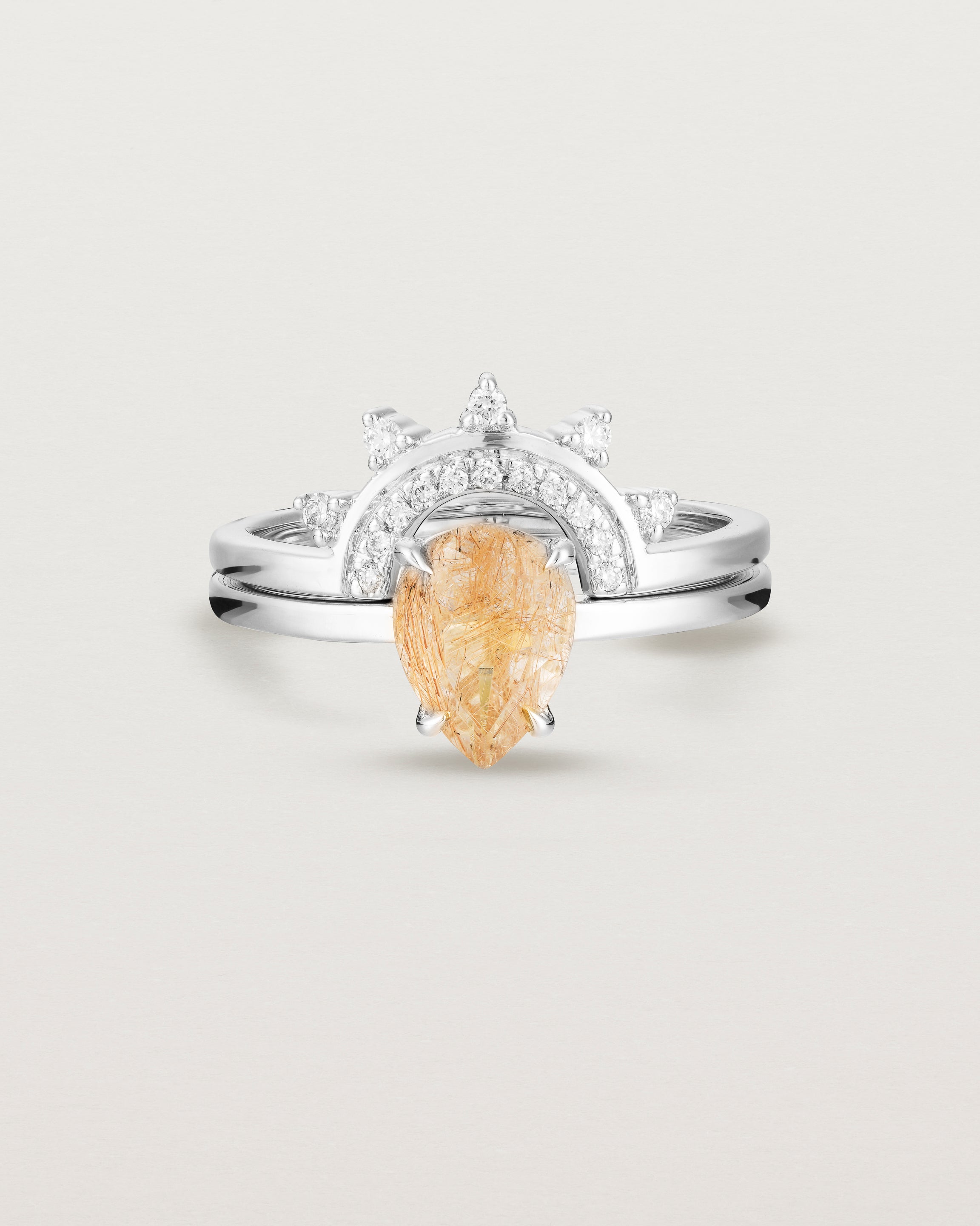 Front view of the Una Pear Solitaire | Rutilated Quartz | White Gold stacked with the Adeline Crown Ring | Diamonds. 
