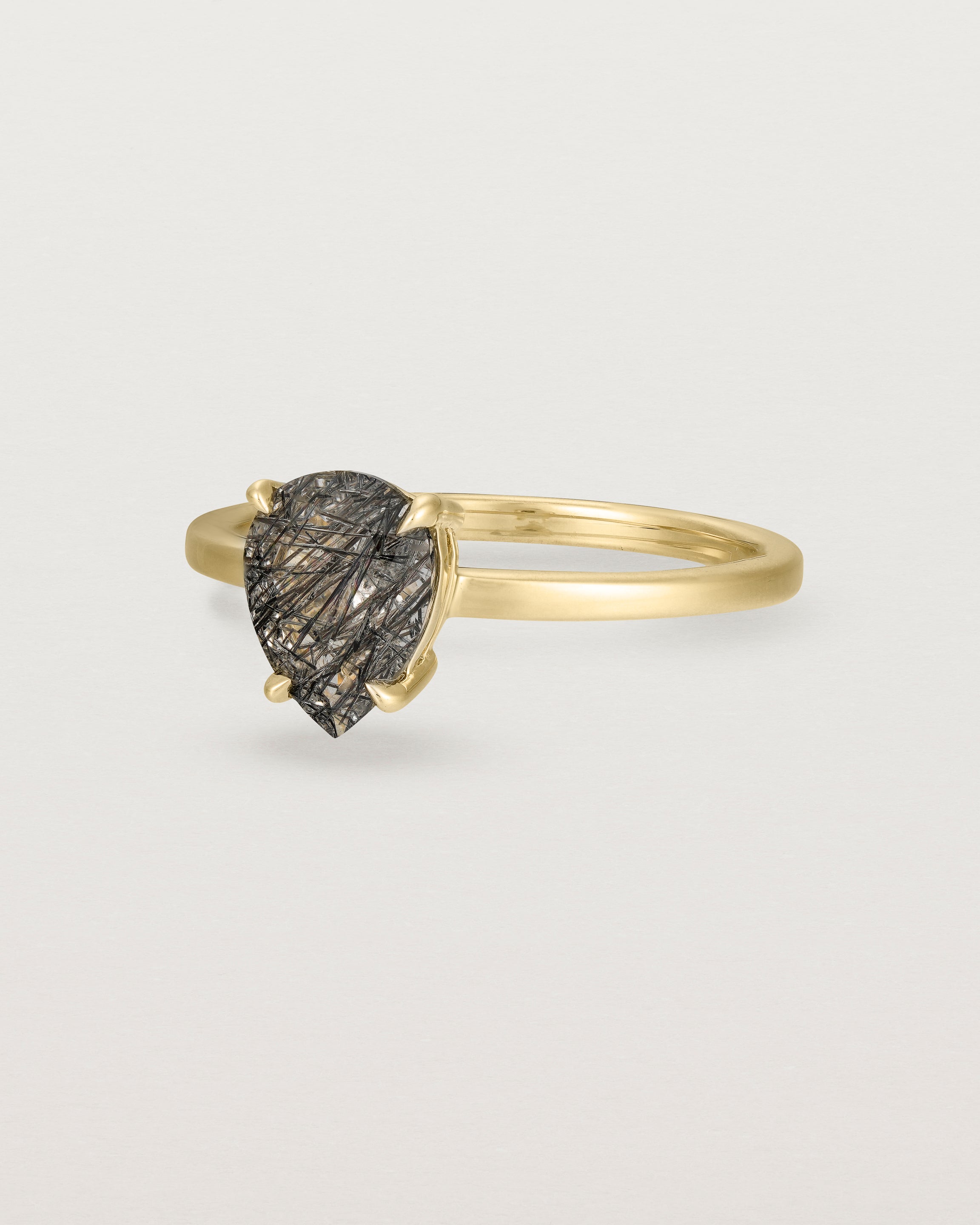 Angled view of the Una Pear Solitaire | Tourmalinated Quartz | Yellow Gold.