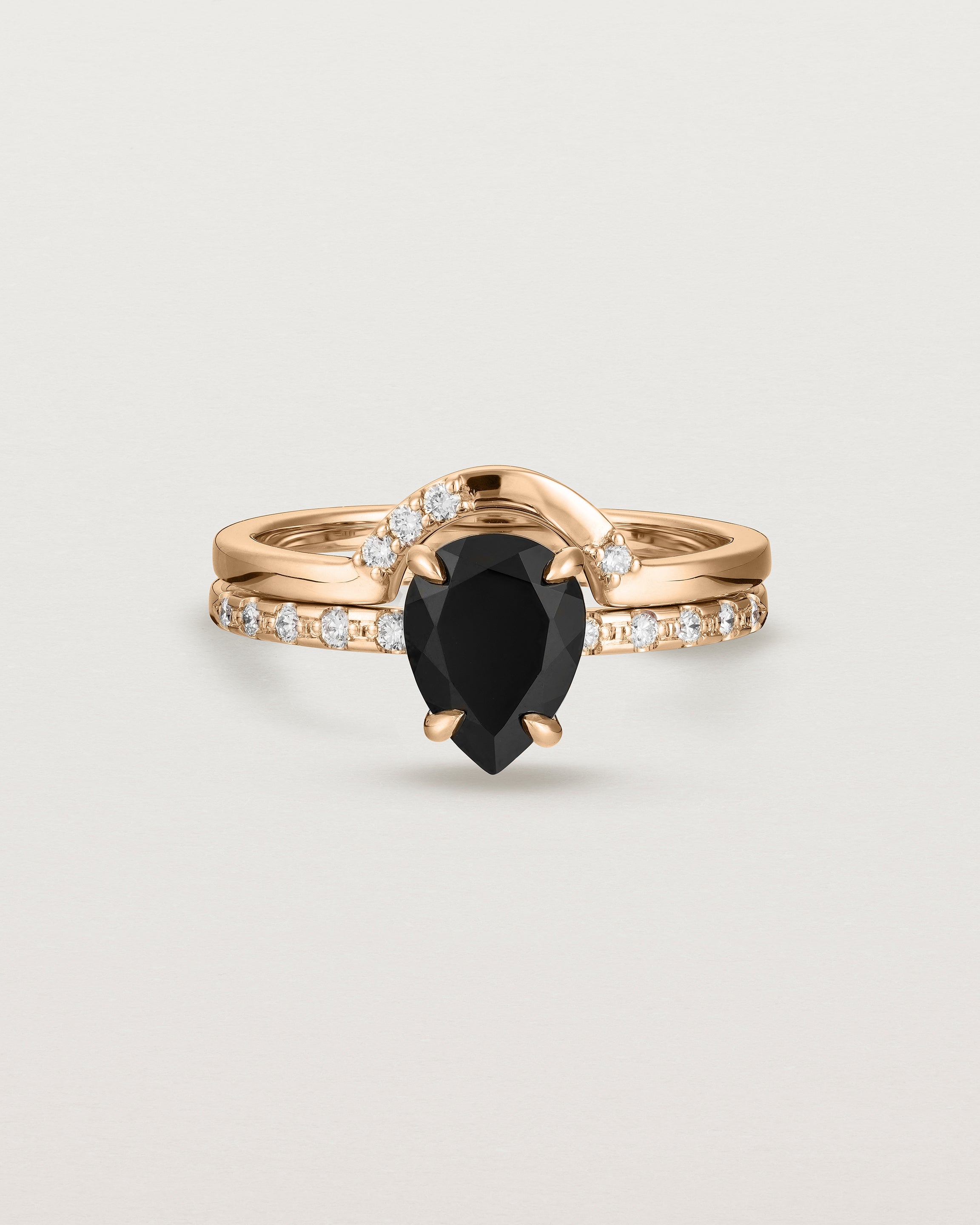 Front view of the Una Pear Solitaire | Black Spinel | Rose Gold with Cascade Shoulders stacked with Cecile Crown Ring | Diamonds.