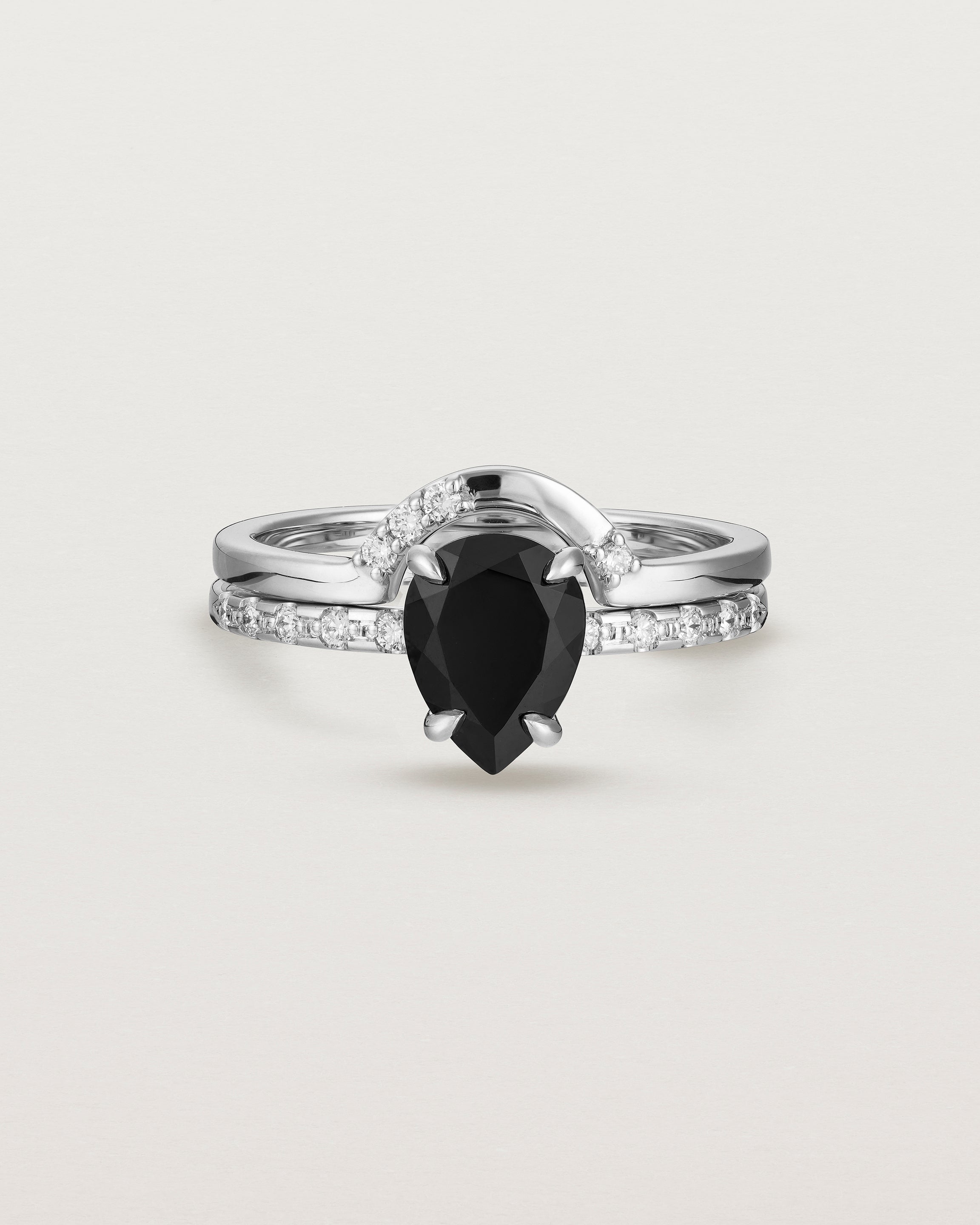 Front view of the Una Pear Solitaire | Black Spinel | White Gold with Cascade Shoulders stacked with Cecile Crown Ring | Diamonds.