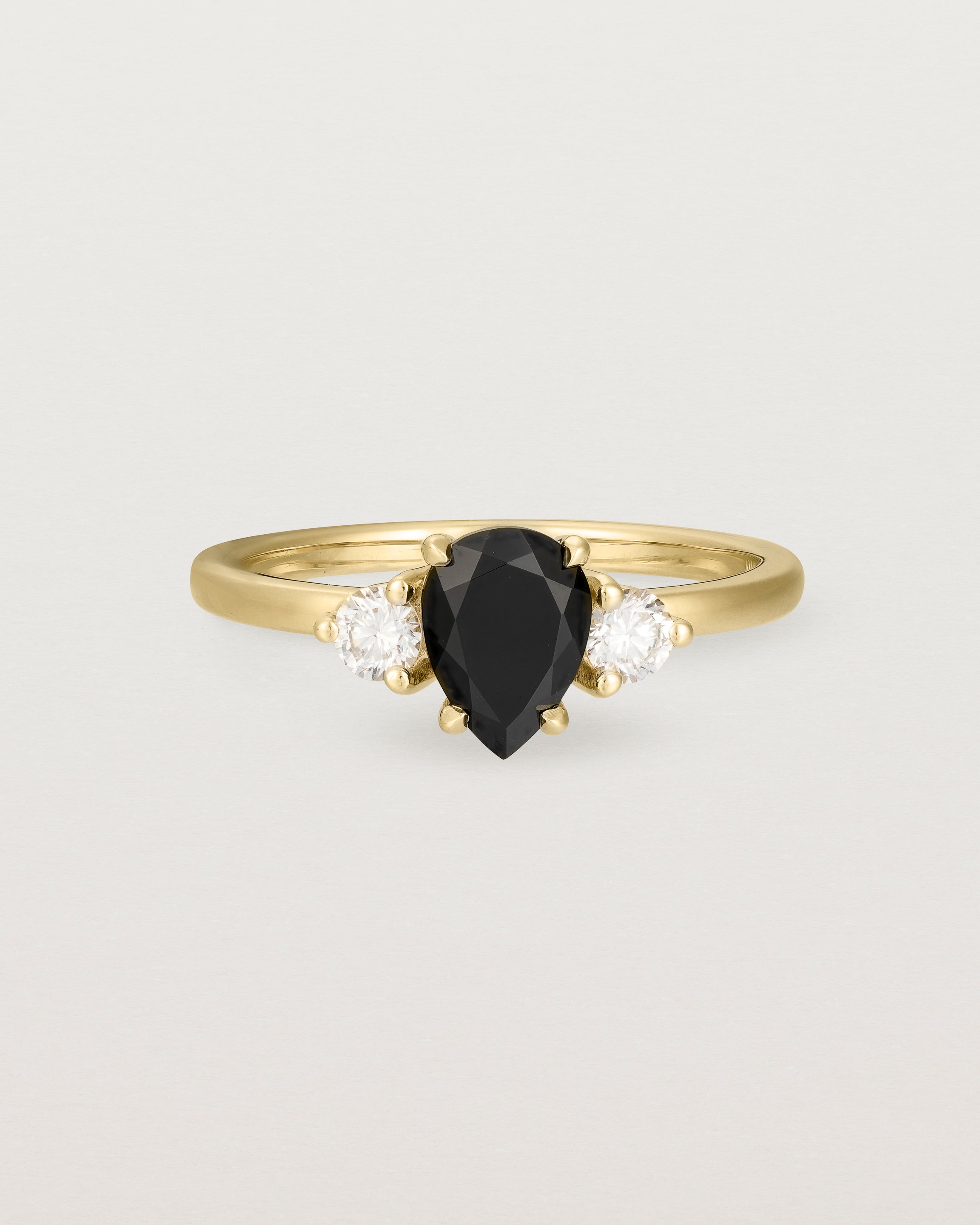 Front view of the Una Pear Trio Ring | Black Spinel & Diamonds | Yellow Gold.