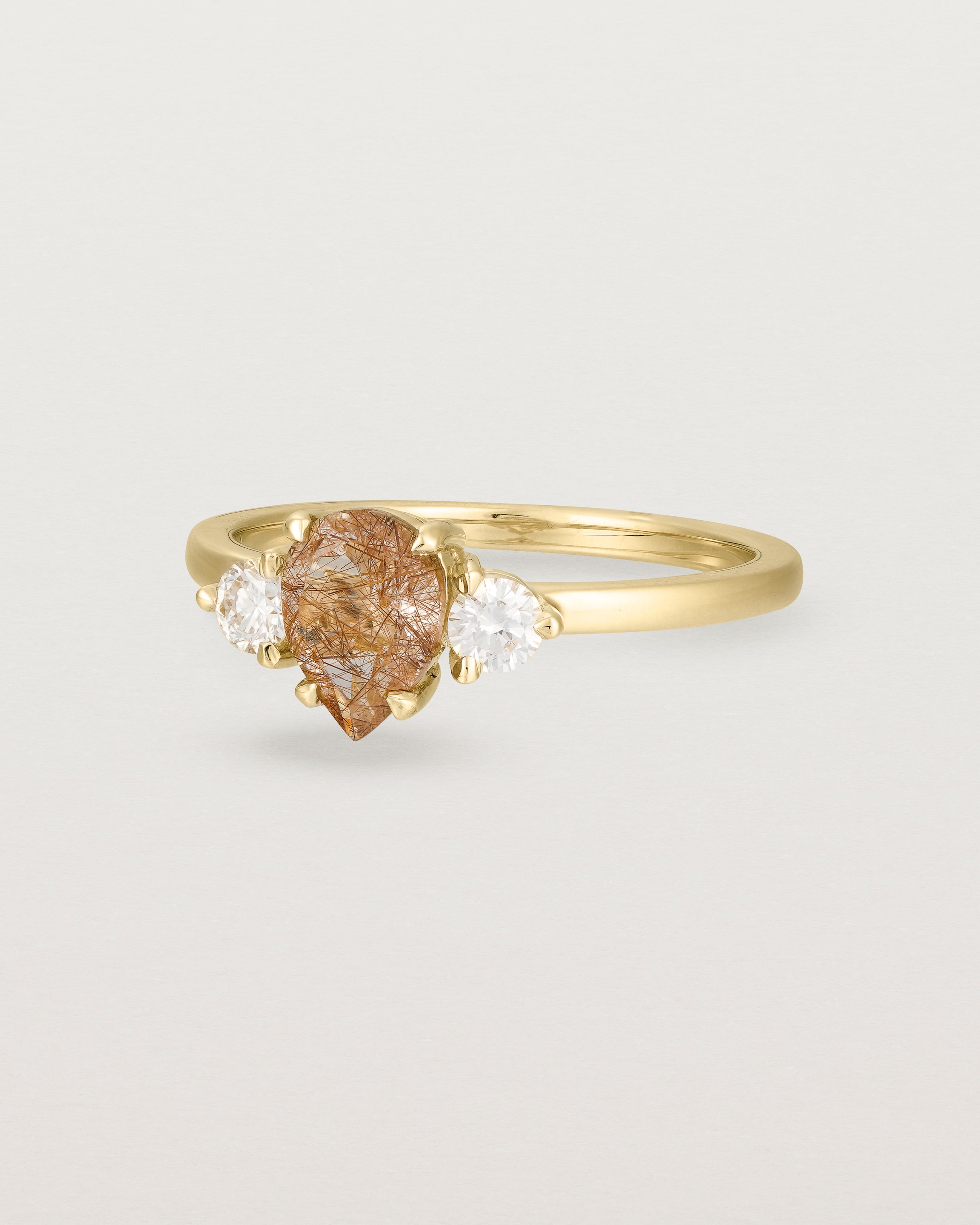 Angled view of the Una Pear Trio Ring | Rutilated Quartz & Diamonds | Yellow Gold.