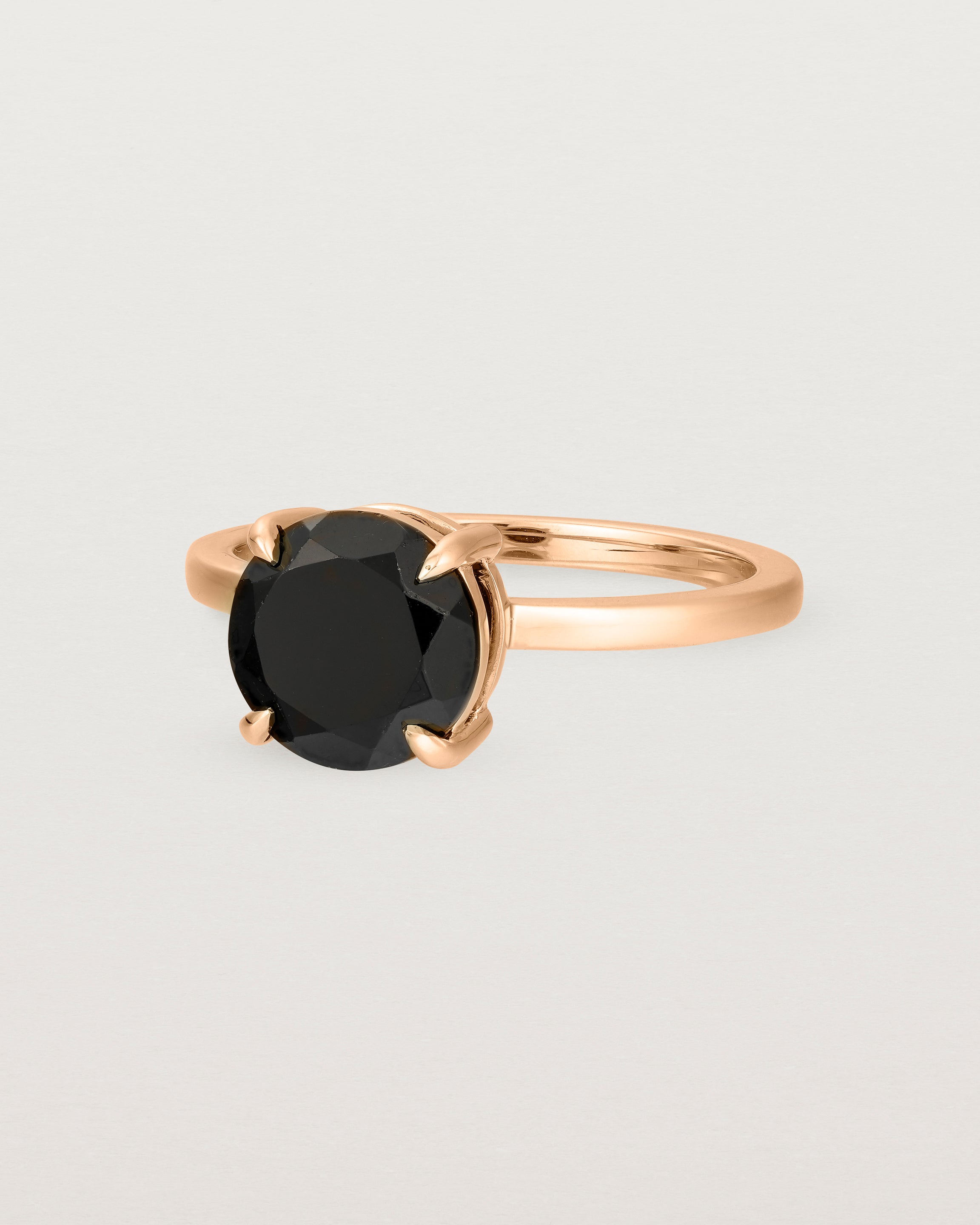 Angled view of the Una Round Solitaire | Black Spinel | Rose Gold