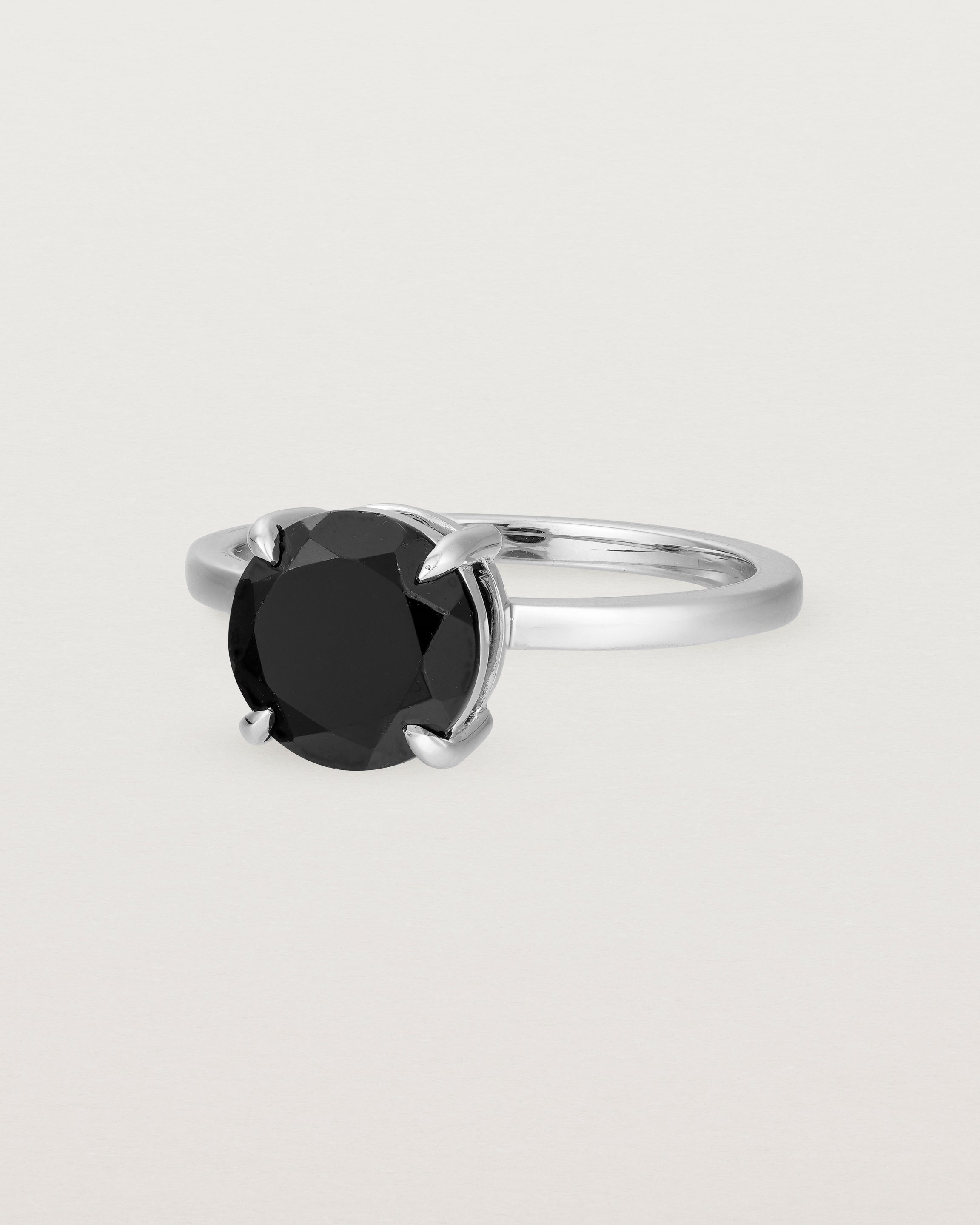 Angled view of the Una Round Solitaire | Black Spinel | White Gold