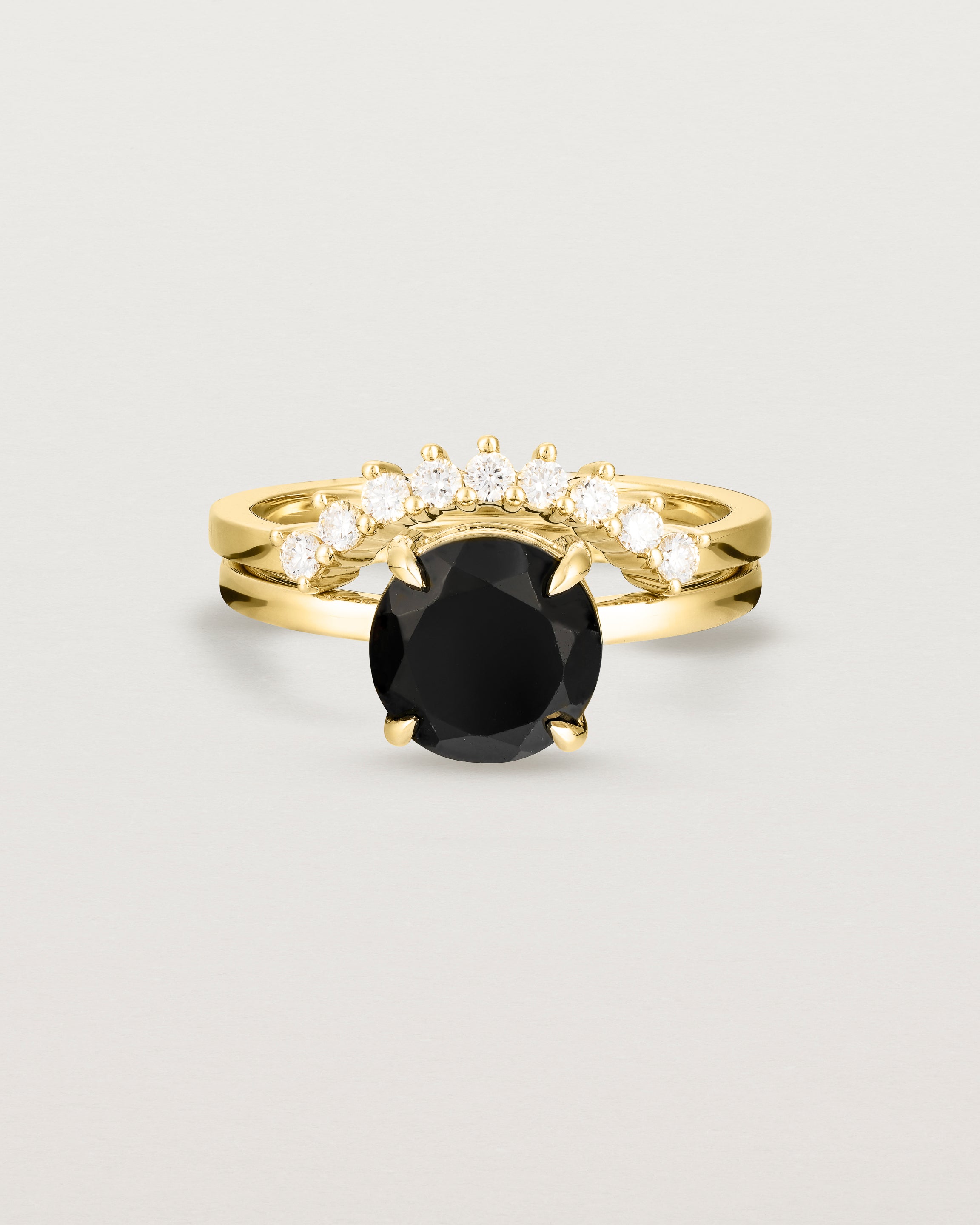 Front view of the Una Round Solitaire | Black Spinel | Yellow Gold paired with the Reina Crown Ring | Diamonds. 