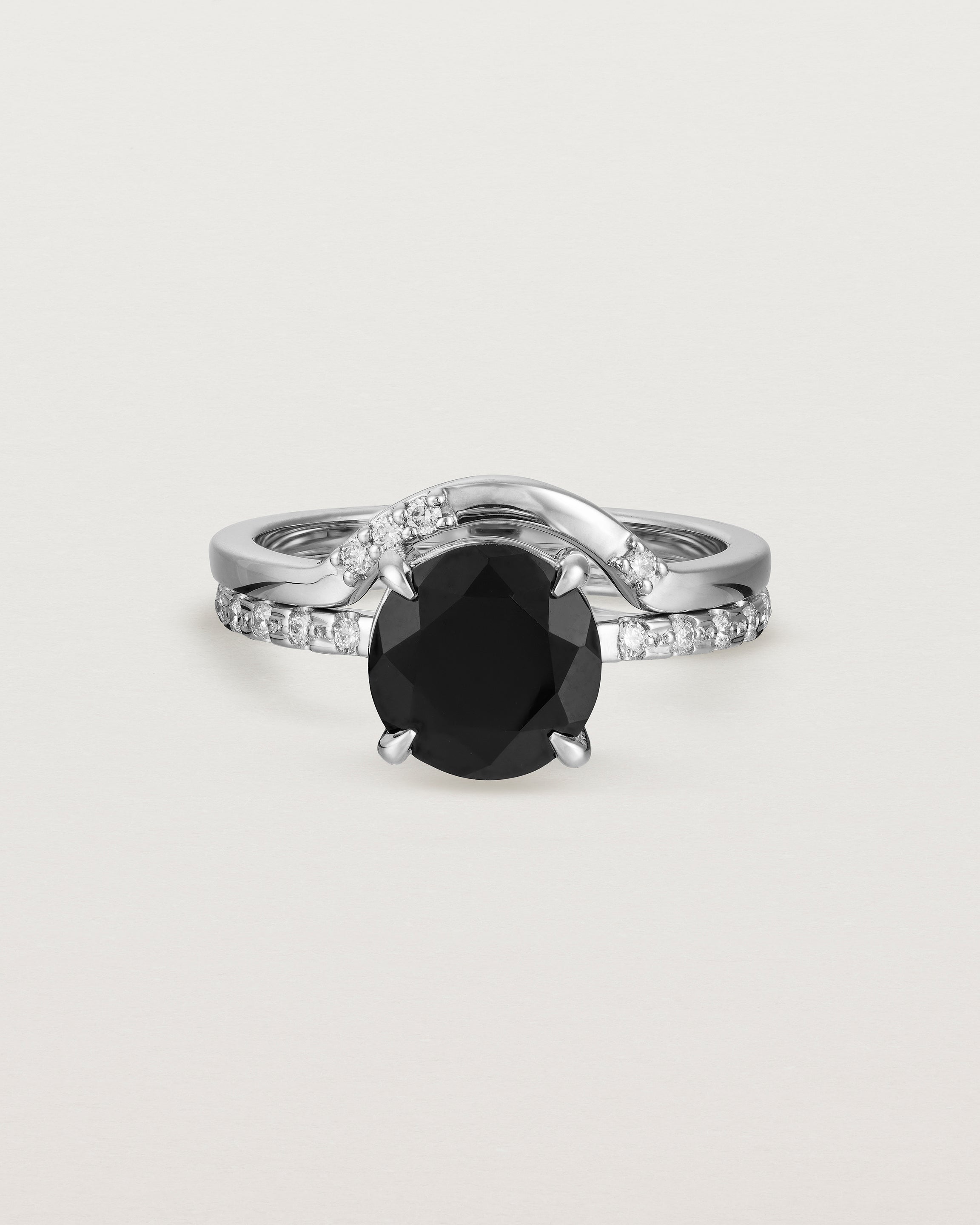Front view of the Una Round Solitaire | Black Spinel | White Gold with Cascade Shoulders stacked with the Cecile Crown Ring | Diamonds