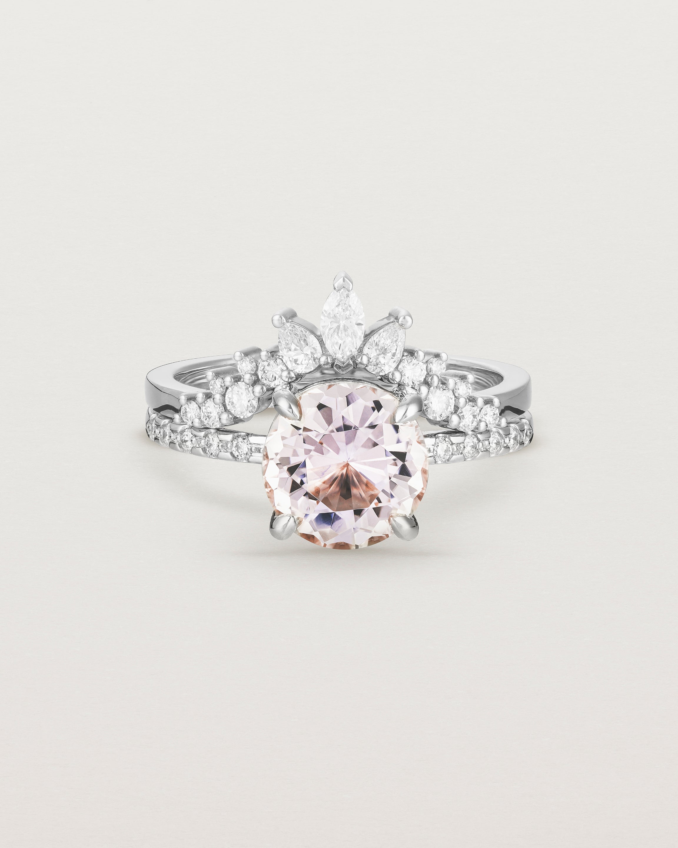 Front view of the Una Round Solitaire | Morganite | White Gold with cascade Diamond Shoulders, stacked with the Thalia Crown Ring.