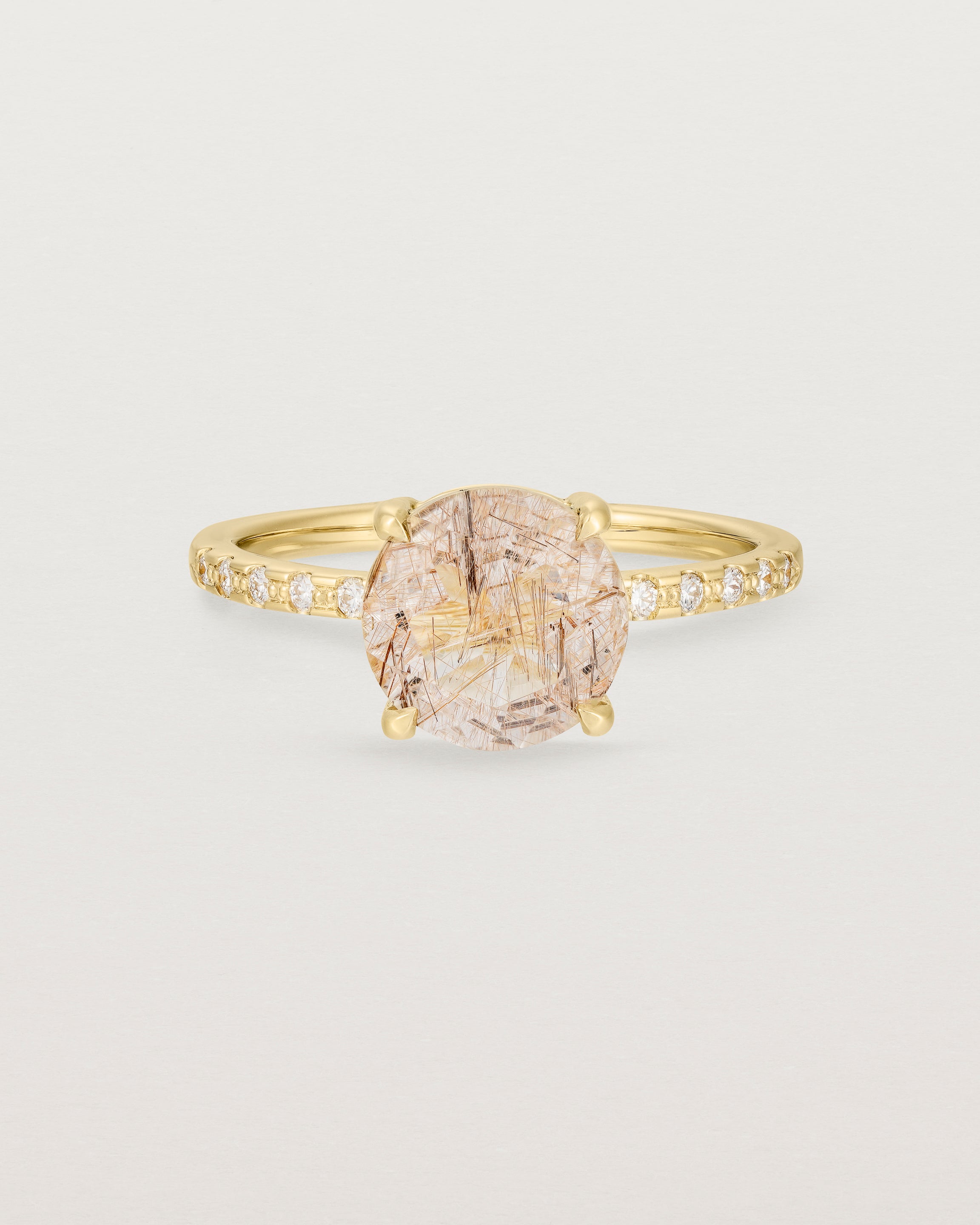 Front view of the Front view of the Una Round Solitaire | Rutilated Quartz | Yellow Gold with Cascade Shoulders.