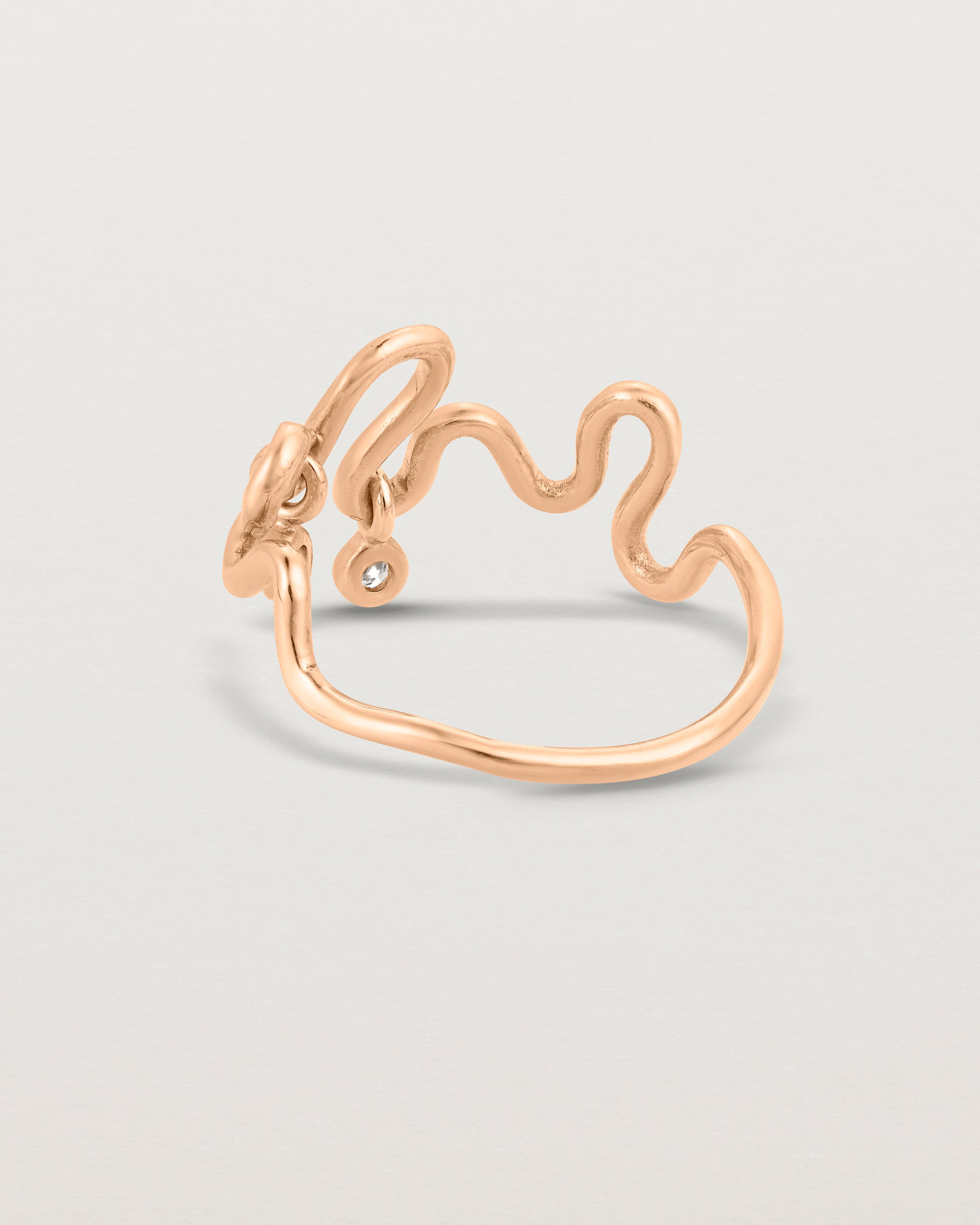 Back facing deep etched image of a rose gold ring with birthstone charms.