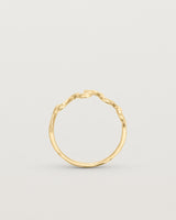Standing deep etched image of a yellow gold ring.