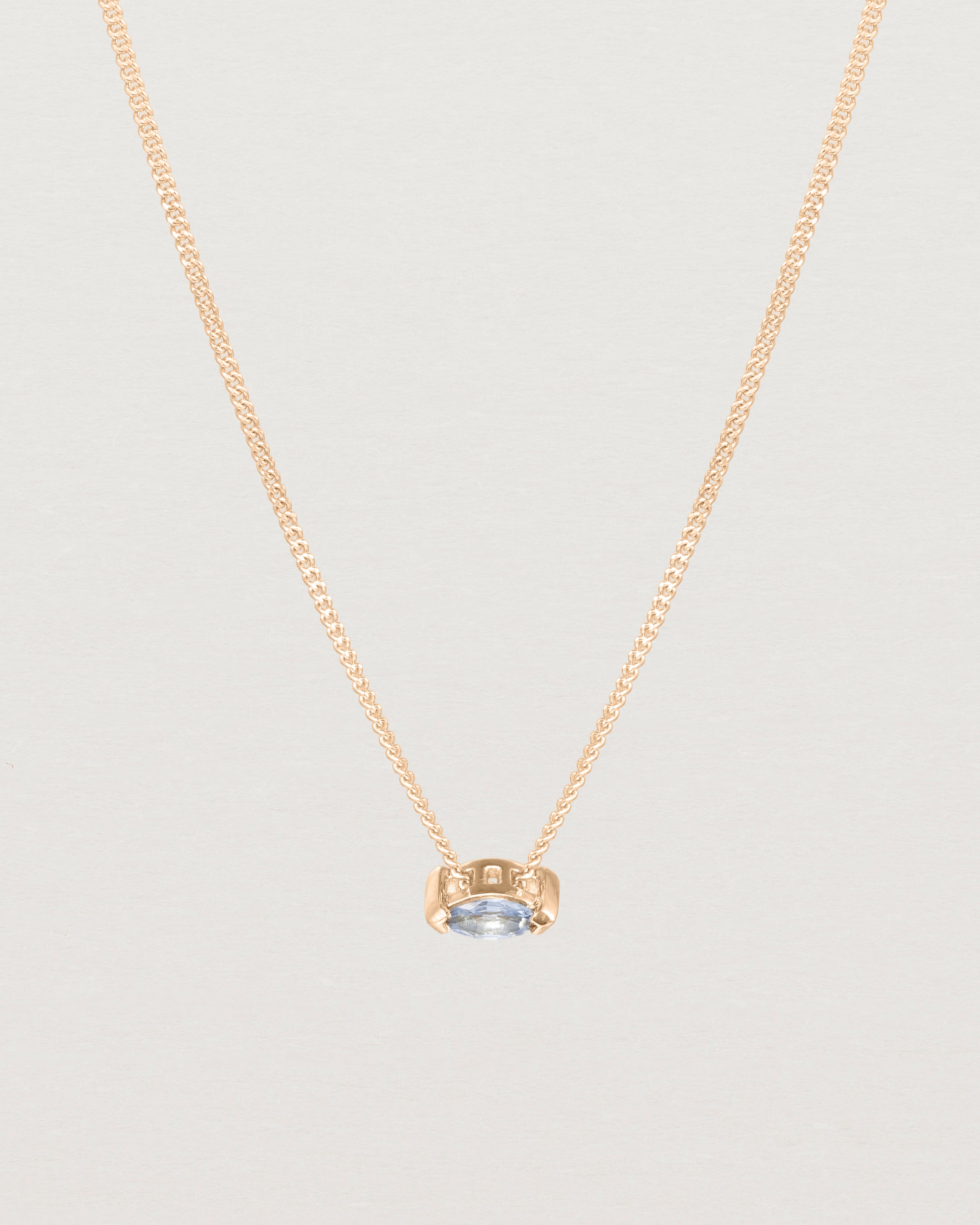 Close up view of the Vega Slider Necklace | Sapphire | Rose Gold.