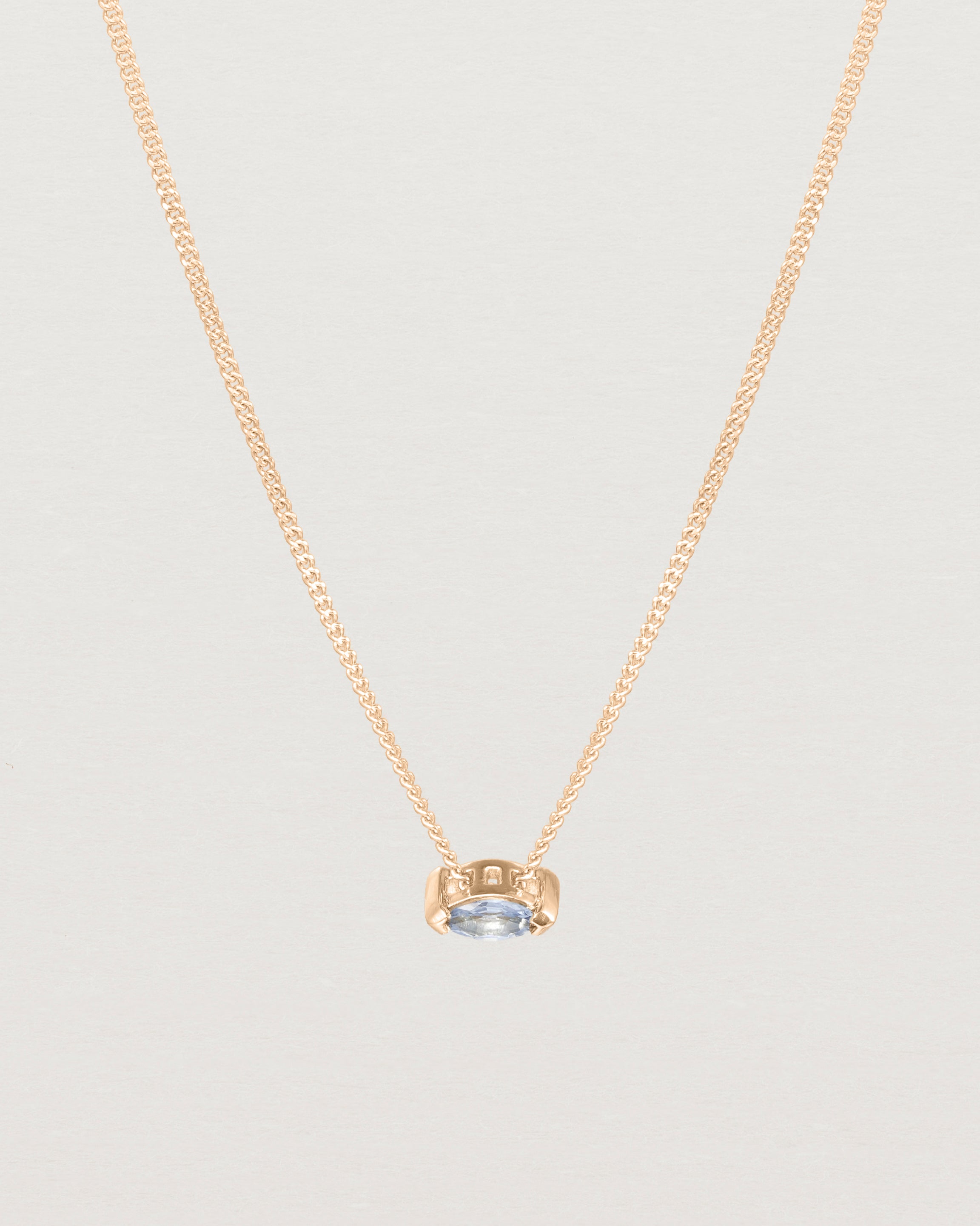 Close up view of the Vega Slider Necklace | Sapphire | Rose Gold.