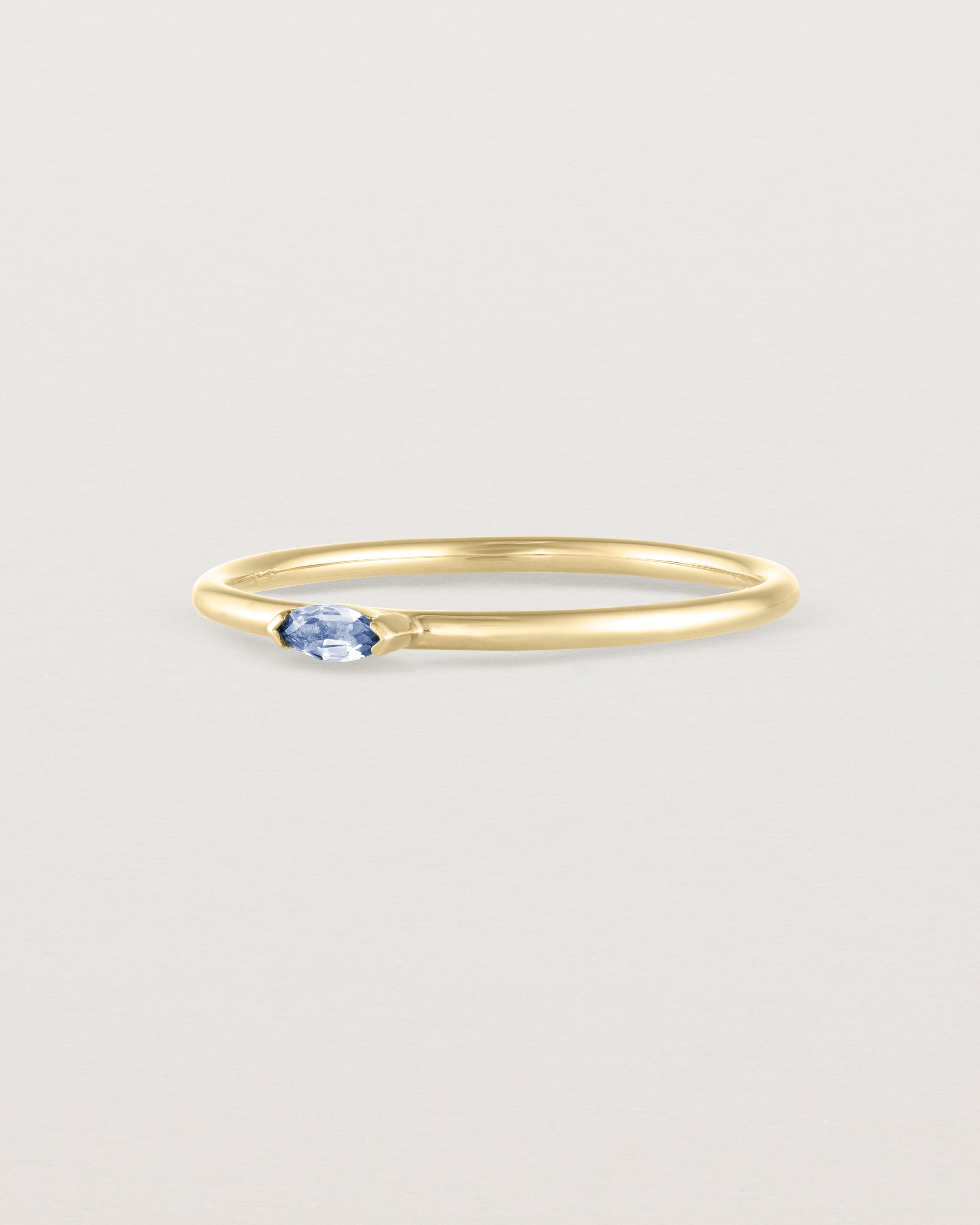 Angled view of the Vega Stacking Ring | Sapphire in yellow gold.