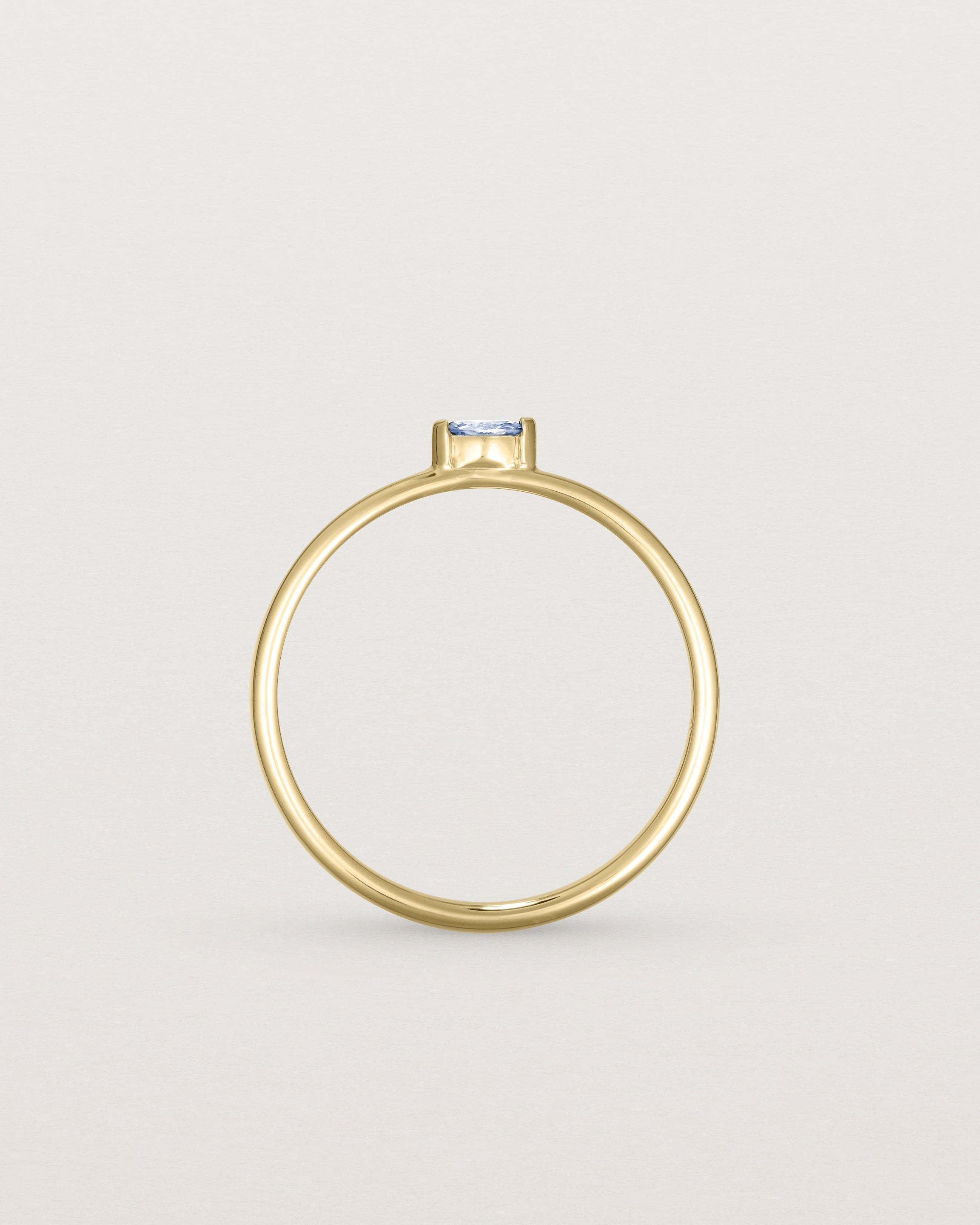 Standing view of the Vega Stacking Ring | Sapphire in yellow gold.