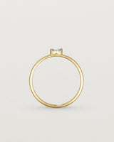 Standing view of the Vega Stacking Ring | Sapphire in yellow gold.