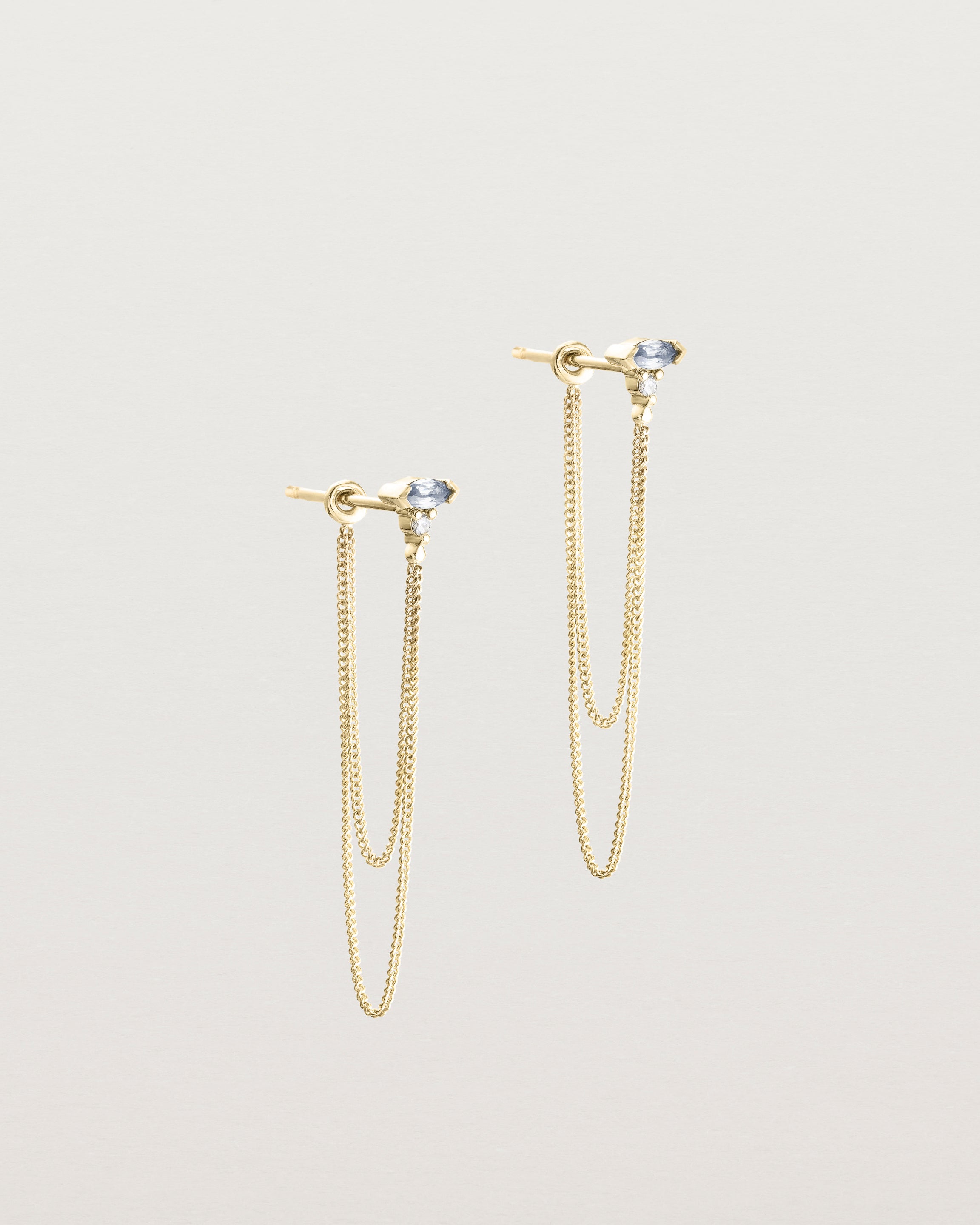 A pair of Vega Loop Studs | Sapphire & Diamond | Yellow Gold.