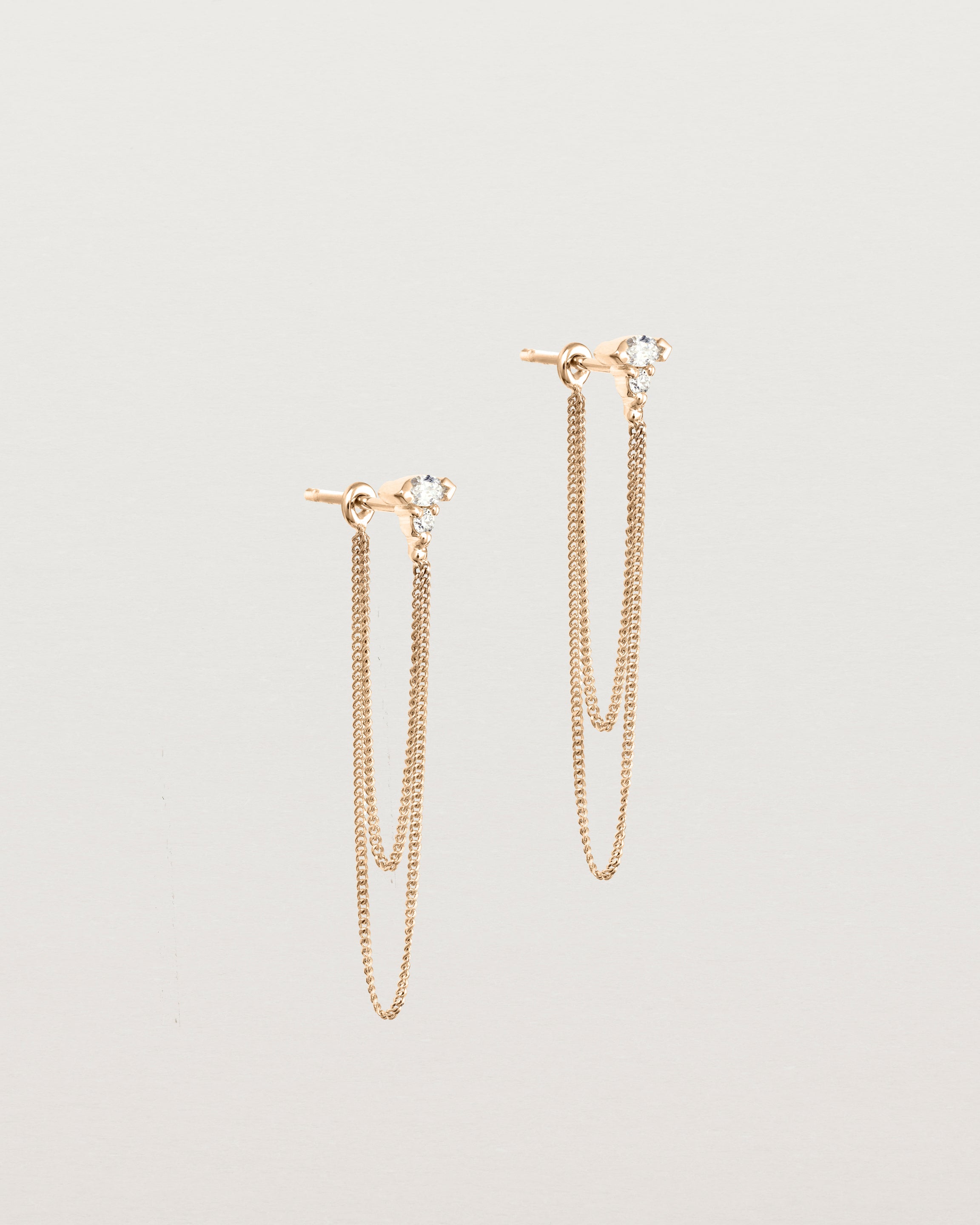 Angled view of the Vega Loop Studs | Diamonds in rose gold.