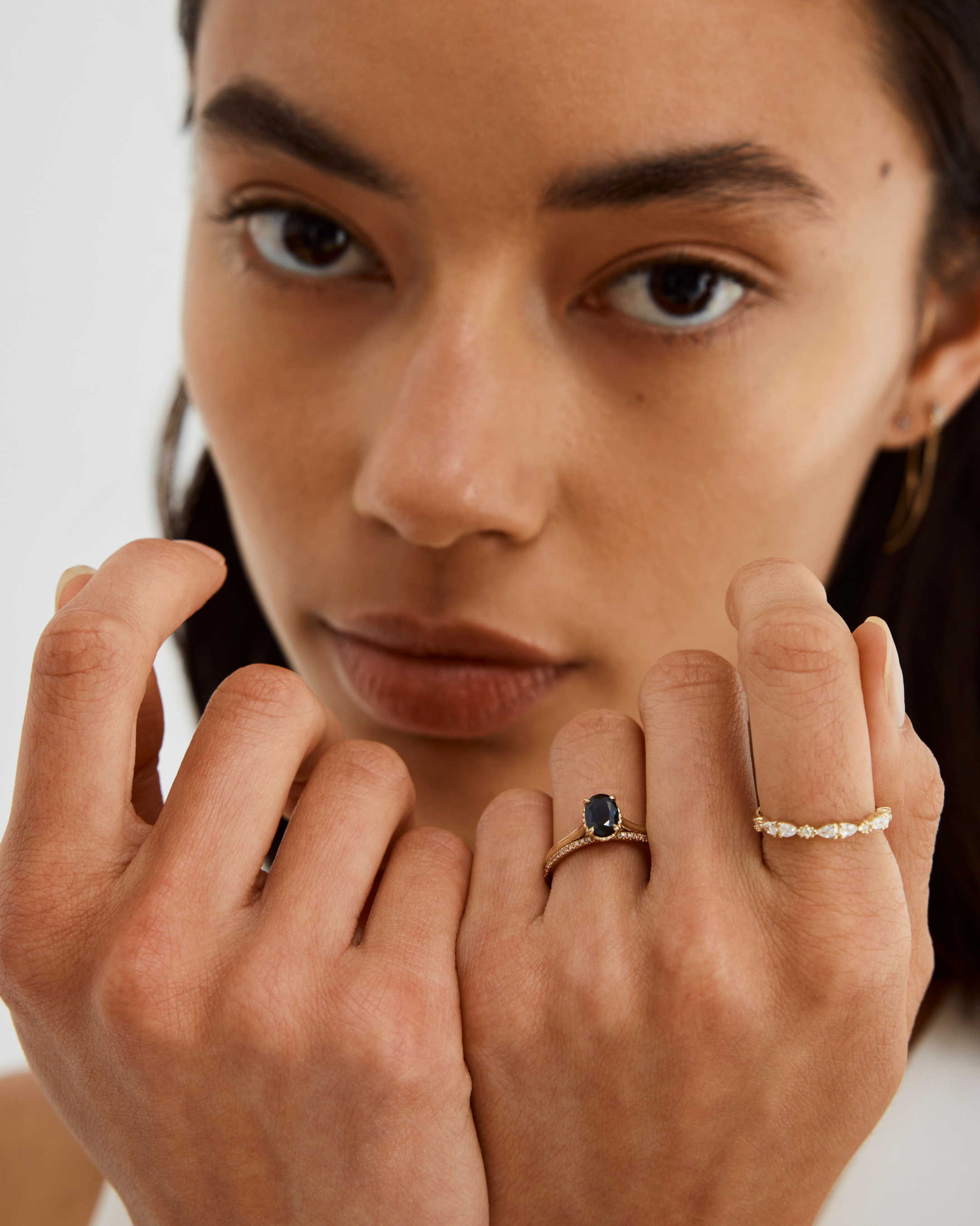 A front view of the Thea Oval Solitaire with a dark blue Australian Sapphire in Yellow Gold. 