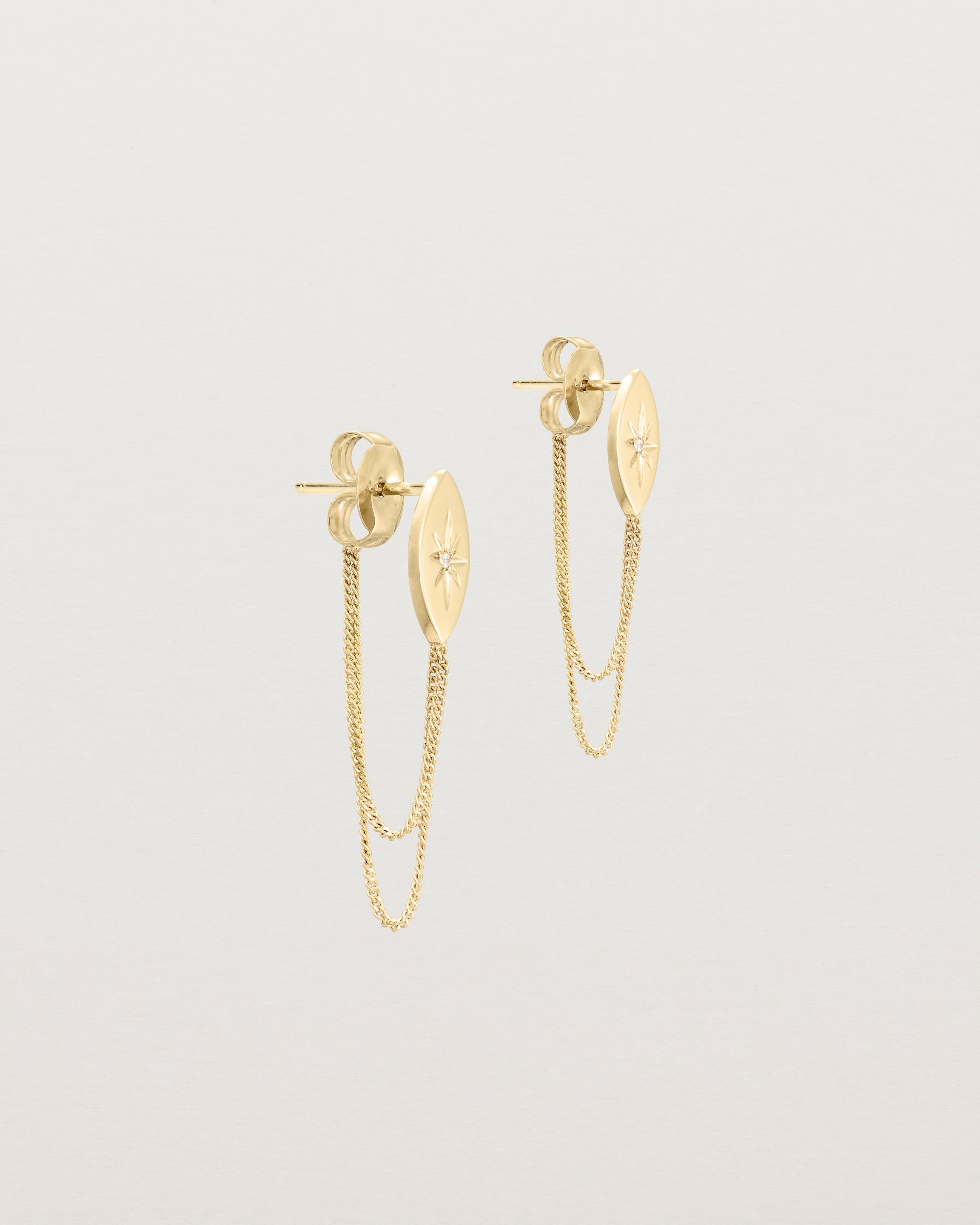 Angled view of the Willow Loop Studs | Birthstone in yellow gold with white diamonds.