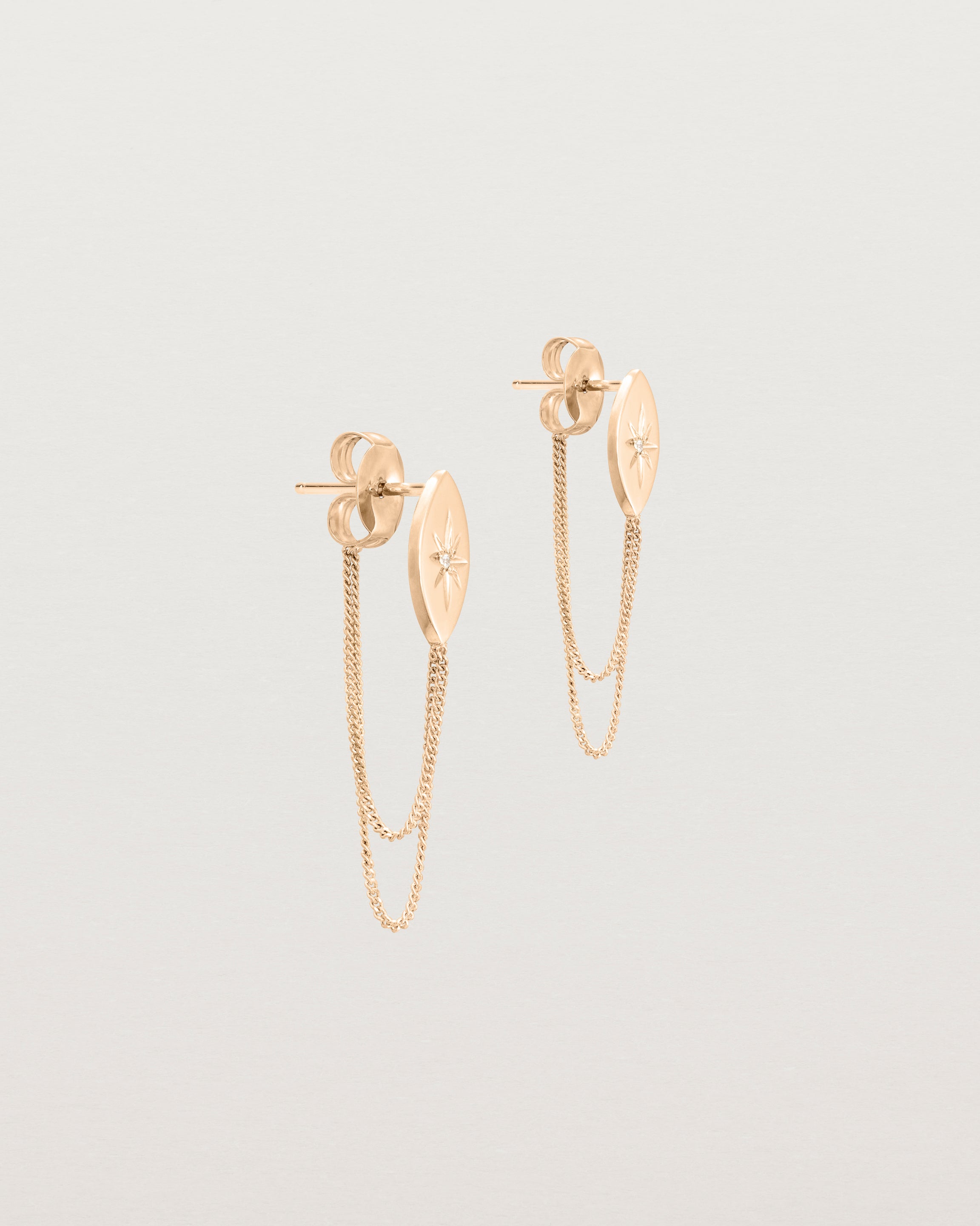 Angled view of the Willow Loop Studs | Birthstone in rose gold with white diamonds.