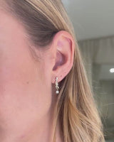 Video of model wearing yellow gold diamond drop earrings