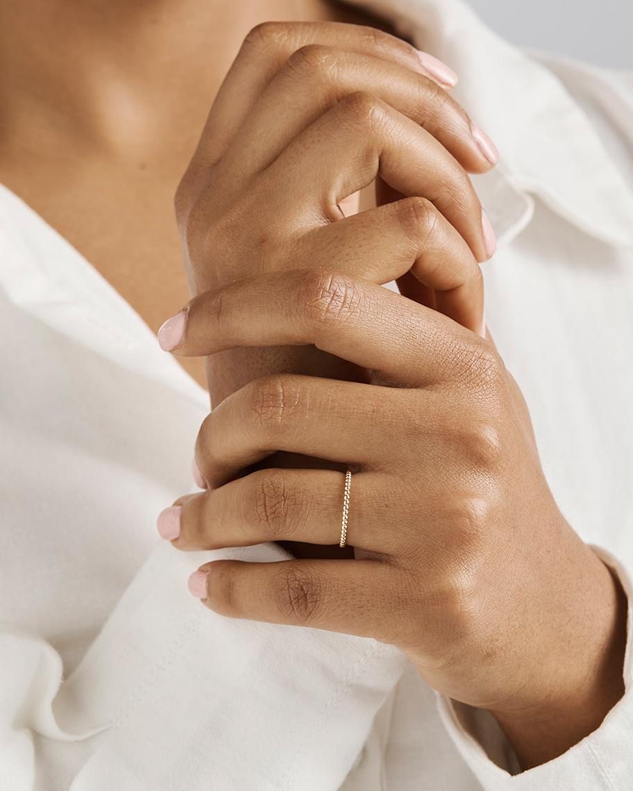 A woman wearing the Dotted Stacking Ring. 