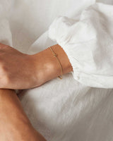 Aether Bracelet in Yellow Gold with one charm.