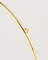 Close up of the detail of the Alya Bangle in Yellow Gold.