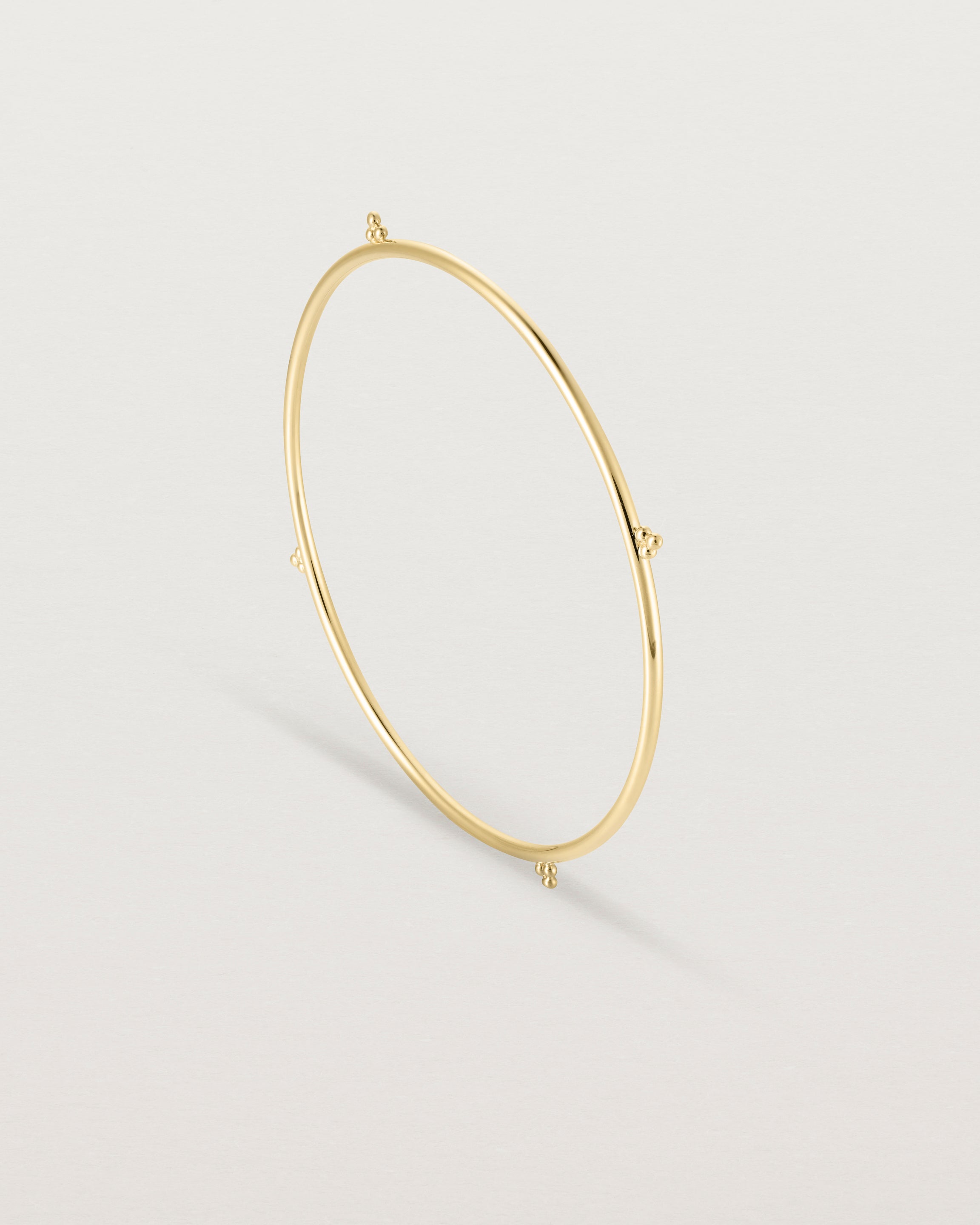 Standing view of the Alya Bangle in Yellow Gold.