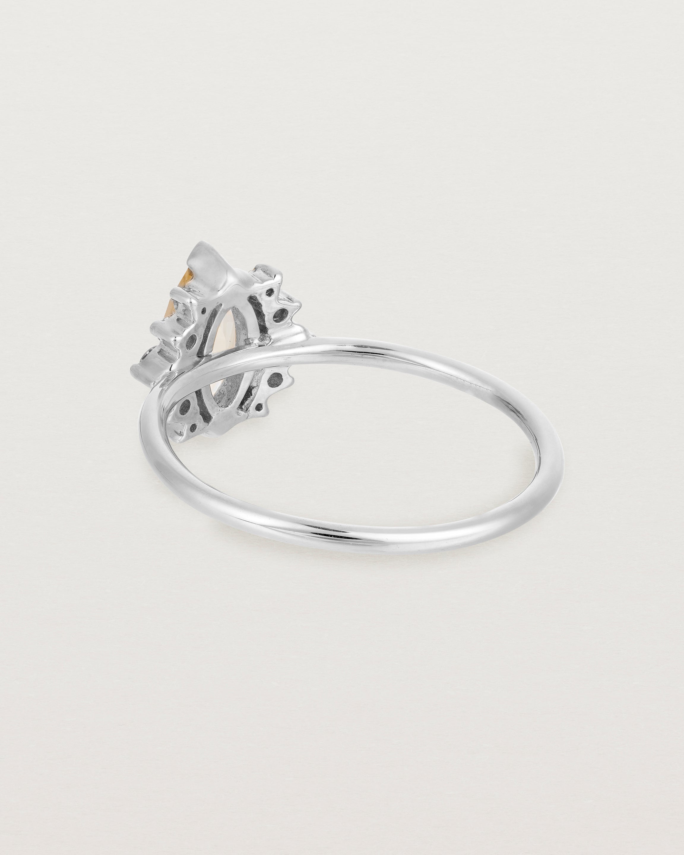 A white gold ring featuring a marquise champagne quartz with a halo of white diamonds