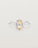 A white gold ring featuring a marquise champagne quartz with a halo of white diamonds